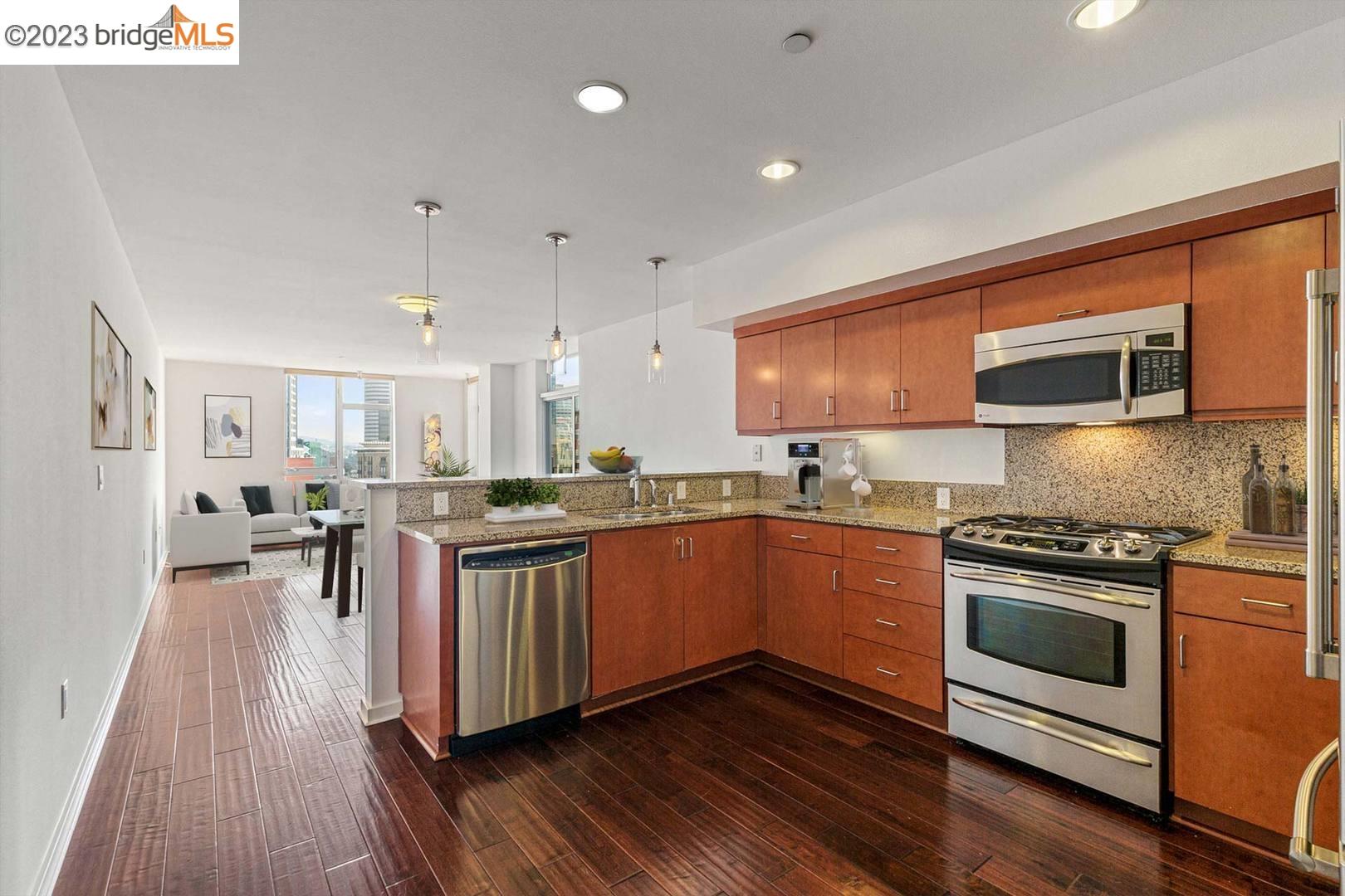Great new price on this stylish, contemporary condo in the heart of Uptown! Spacious one-bedroom floor plan featuring an open layout and a sleek, modern vibe. The well-appointed kitchen includes stainless steel appliances, granite countertops, and bar seating.    The ample living and dining areas glow with gorgeous southern light and are ideal for entertaining. The adjacent private balcony offers the perfect place to relax and enjoy the views of the Oakland skyline and beyond.    Down the hall is the full bath with a soaking tub and the bedroom, which features more skyline views from a picture window and a walk-in closet. There’s excellent storage space throughout this unit with multiple large closets.    Great central location just blocks from restaurants, bars, BART, and more. Lovely building amenities including fitness + community room, outdoor courtyard. HOA fees include gas, water, trash, internet. One deeded parking space in building garage and in-unit laundry, too.