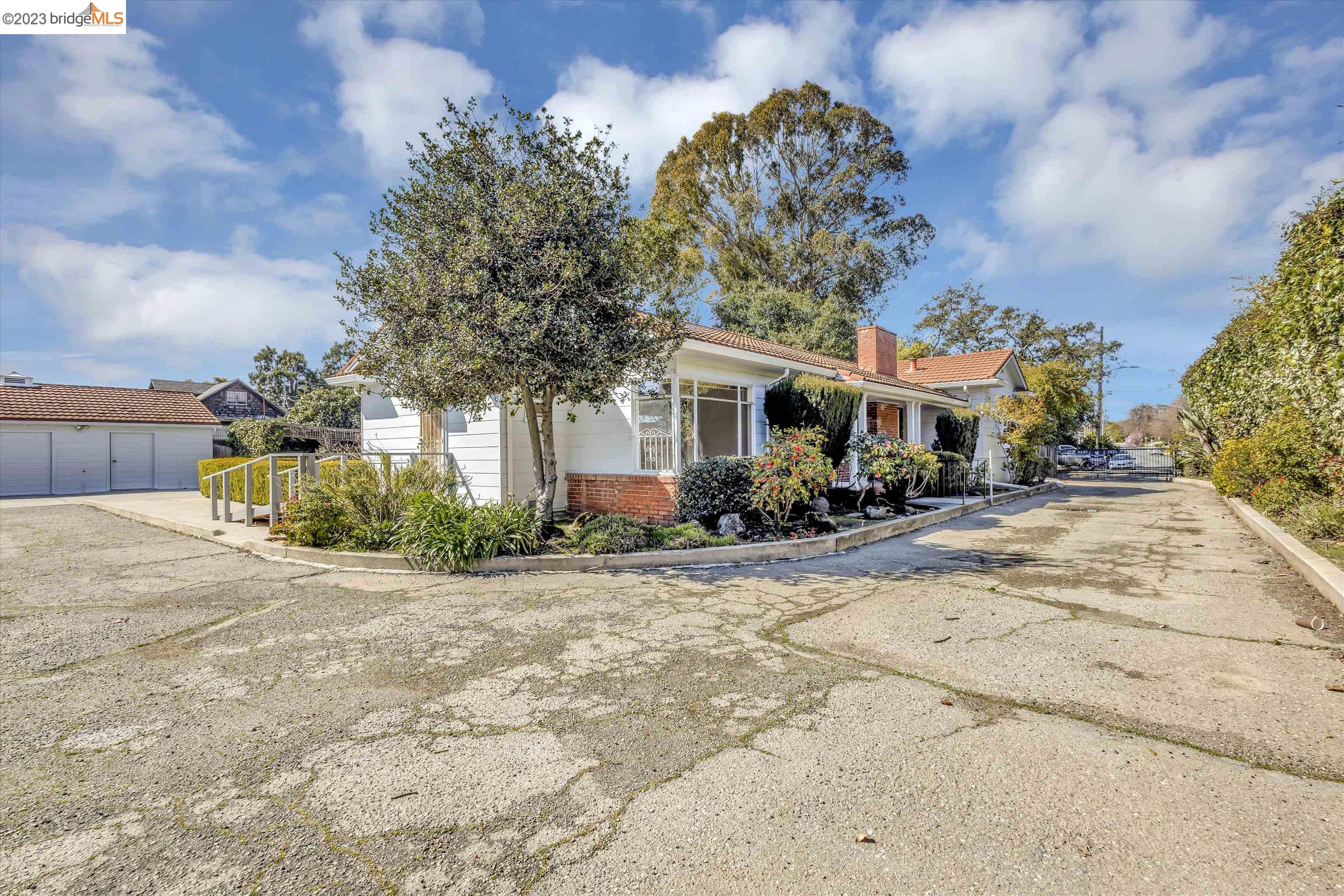 Urban Oasis at Peralta Creek! This compound retreat  is a very solid house with lots of land. (almost 21,000 sq ft lot) This huge flat lot is gated and secluded at the end of a cul-du-sac. There is parking for every car, boat or RV. Fruit and avocado trees surrounds this mid-century ranch home that boasts hardwood floors, an eat-in kitchen, a real basement with a bar, a metal shingle roof and gardens galore! Plus, there is a three-car garage. This is all wrapped up in a very private urban setting.