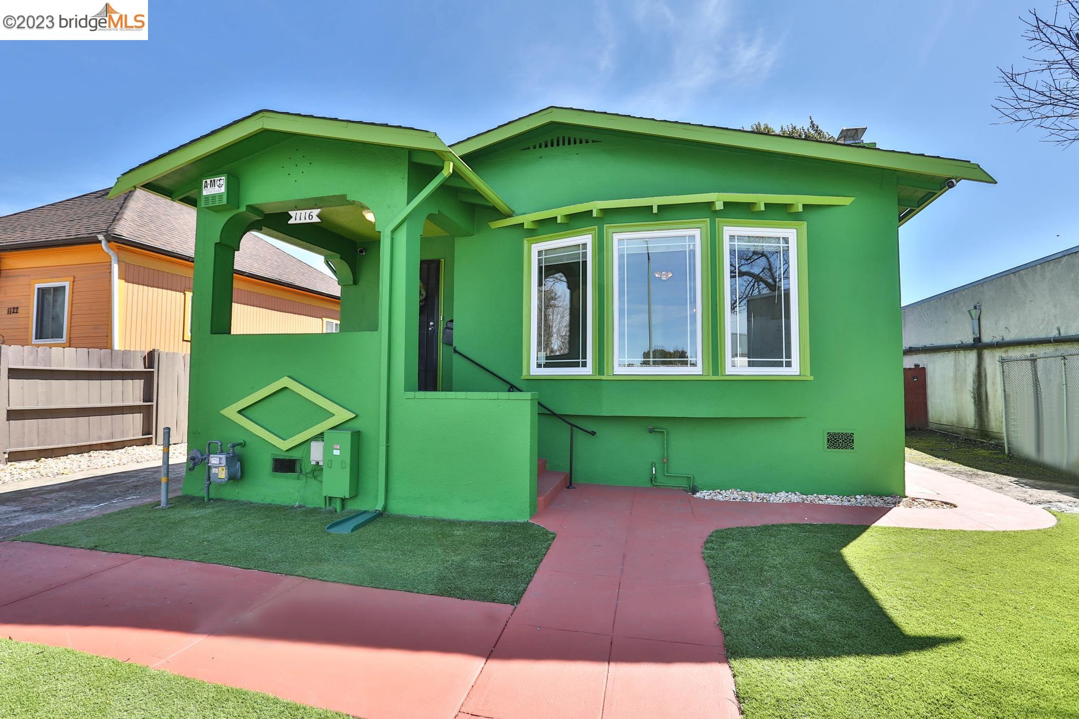 Vibrant, well-maintained home with a park like backyard in Oakland! Inside, step through a foyer and into the bright living room lined with bay windows, wood-burning fireplace, and authentic stained-glass details. Charming French doors connect to a formal dining room with original built-ins. Continue through to a generous eat-in kitchen with plenty of counter space & storage. Step downstairs to access the attached garage, lower den, and versatile finished sub-basement. Outside, the substantial backyard is extra deep and spacious, with mature trees and a grassy lawn. The main floor includes one bedroom and a full bathroom with a tub/shower & new vanity. Upstairs, find two additional bedrooms with large closets. Property is gated with ample driveway. Residential neighborhood conveniently located close to transit hubs.