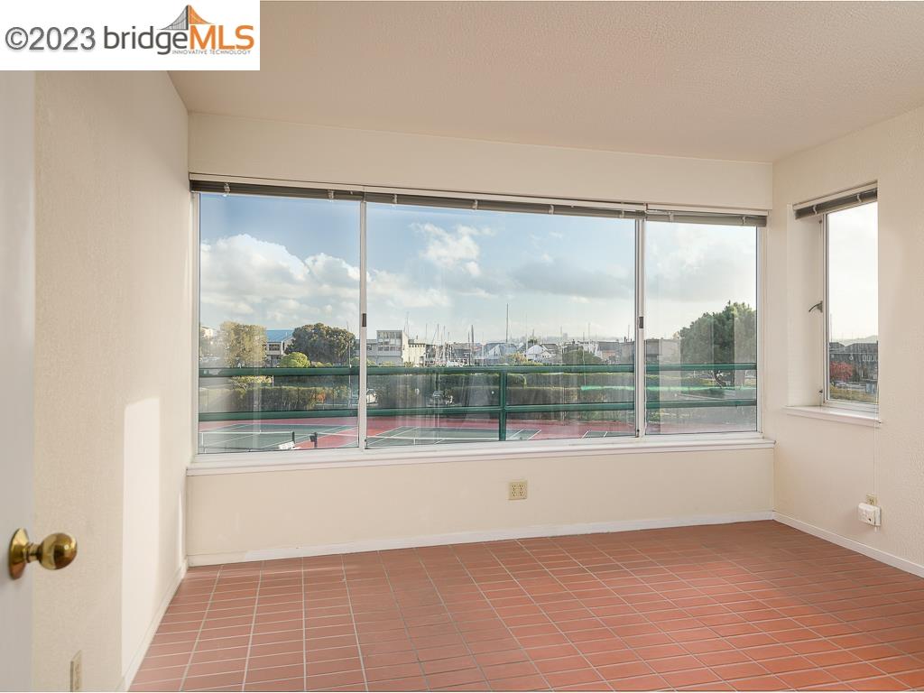 Turn on your sound and watch the video!  https://youtu.be/ke9yS3FEPA8   This 2 bedroom, 2 full bath Brickyard Landing condo boasts beautiful laminate flooring, a feature ONLY allowed in first-floor units. The kitchen appliances and tub surrounds have been updated. From the large (12' x 12') solarium, look out over the manicured lawns, across a private cove, and on to a lovely view of San Francisco. On cool nights keep toasty warm snuggling in front of the beautifully remodeled wood-burning fireplace. Or relax on the spacious outdoor covered patio. Feeling more active? Enjoy the resort-like facilities including a year-round outdoor heated pool and hot tub, gym, sauna, tennis and pickleball courts, clubhouse, community garden, and EV chargers. Quick access to Berkeley, Oakland and Marin via 580; take the Richmond ferry to SF; or hop on Amtrack or BART at nearby stations. Across the street from Richmond Yacht Club and Brickyard Marina. Stroll or bike the Bay Trail to the restaurants and shops in historic village of Point Richmond. Hike the nature trails through the hills bordering Brickyard Landing complex. Washer/dryer are included with the purchase as well as 2 parking spaces and storage lockers located in the below-building garage.