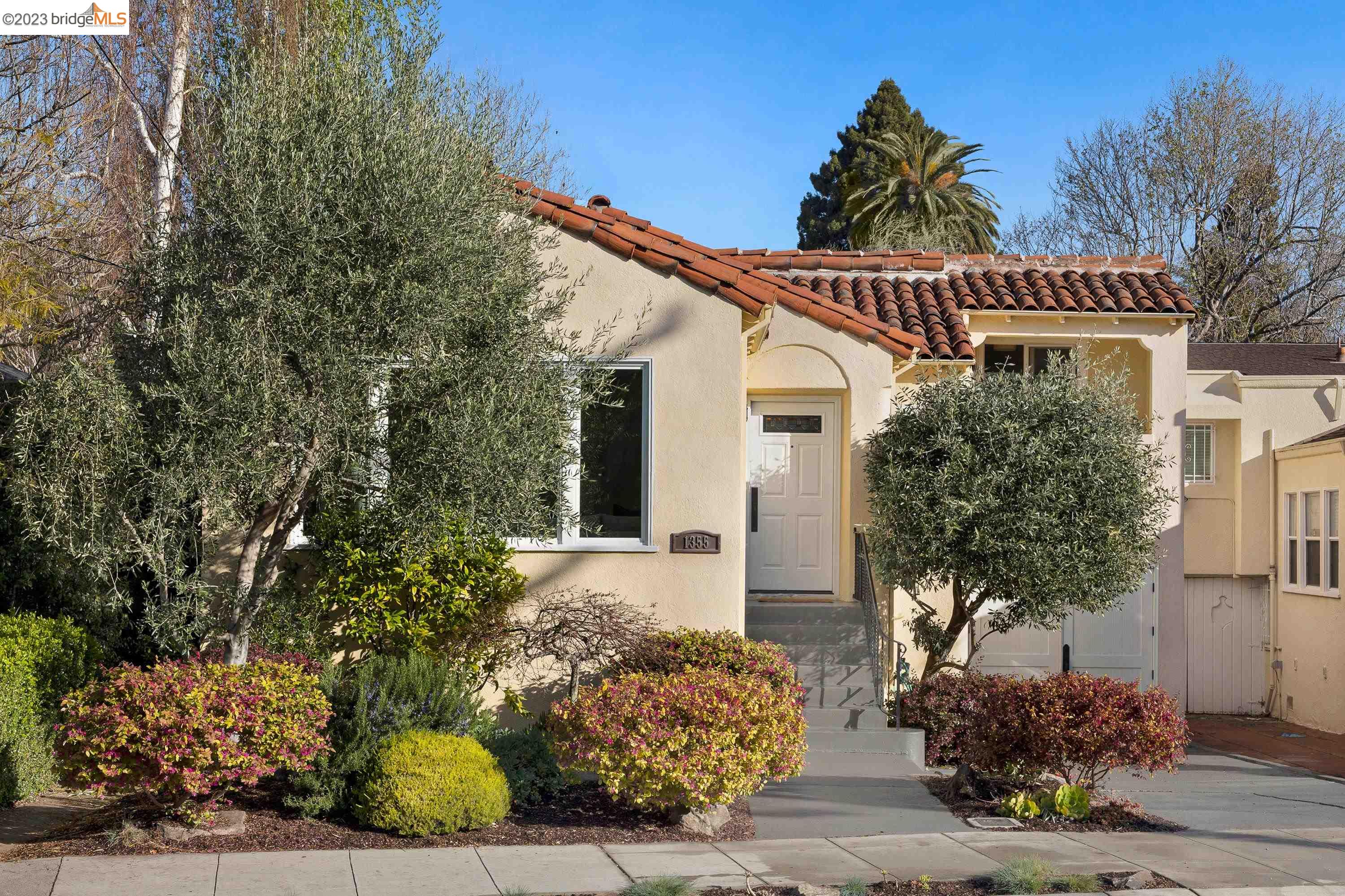 Special home on quaint street in Northwest Berkeley. 3-bed, 2-bath mediterranean is perfectly updated w/ period touches. Beautiful sunlit living room overlooking olive tree + warm fireplace. Updated eat-in kitchen w/ cherry cabinets, stainless steel appliances. Upper level with 2 large bedrooms, one with balcony access. Flexible lower level can function as secluded primary or great family room w/ a full bath. Additional basement workshop space + interior access to garage w/ laundry. Enjoy the large backyard with fruit trees + stone patio. Plenty of off-street parking close to North Berkeley BART, Hopkins, Fourth St + more!