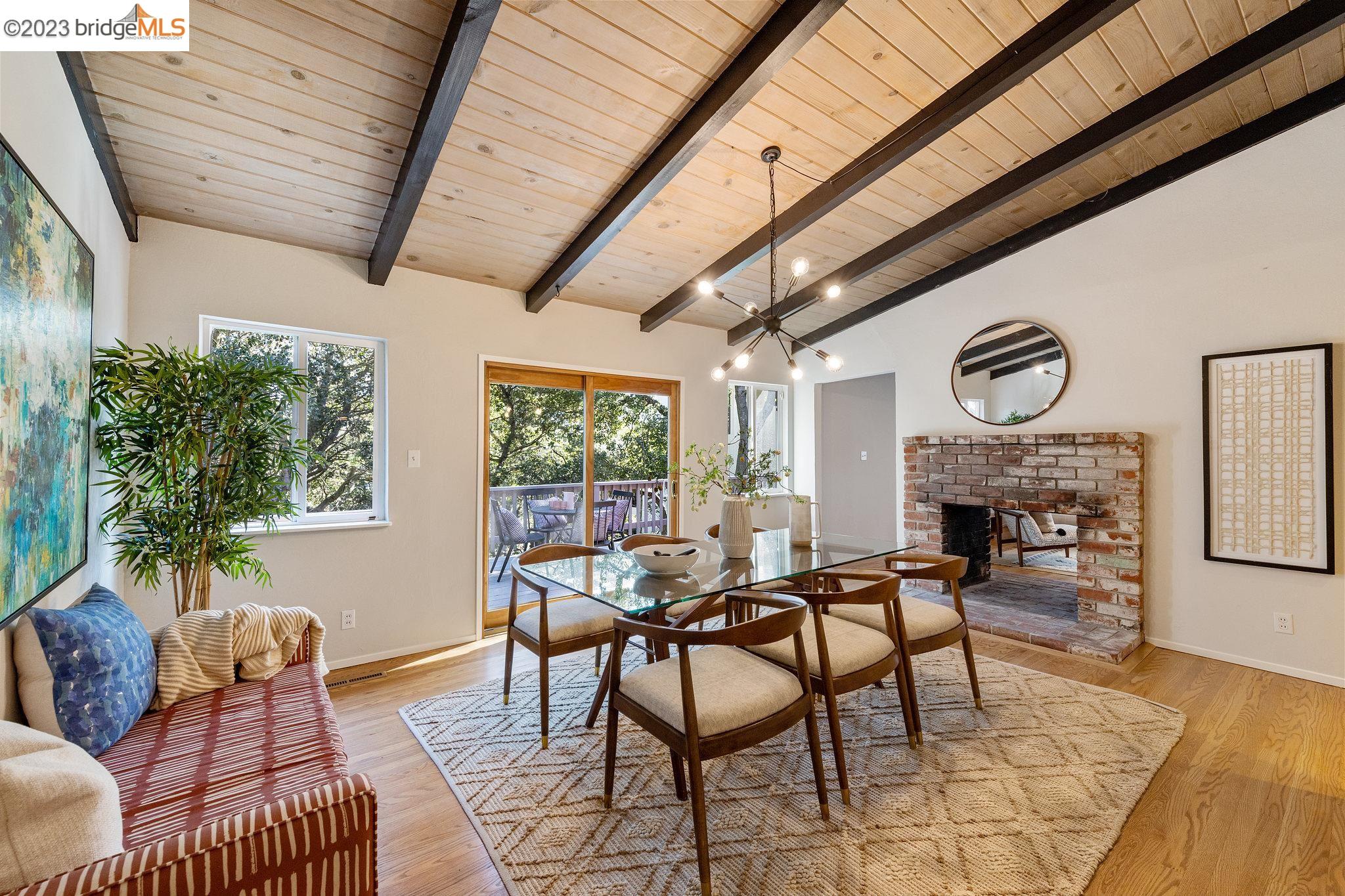 Welcome to 11037 Broadway Terrace, a spacious Mid-Century era home set amongst the trees in Oakland's Montclair district. Home offers 2Bed, 2Baths, & a huge bonus space/family room downstairs.The dining room is the jewel & heart of the home, featuring wood cladded ceiling, exposed beams,& a sliding glass door out to large deck offering breathtaking views of the trees & hills. The double hearth fireplace is a centerpiece of both the living and dining rooms and the open layout of the living room, kitchen, & dining room provides the perfect space for family gatherings. Kitchen features unique vintage details including distinctive cabinet pulls, pristine laminate counters, & spotless built-in oven. Main floor comes w/ gorgeous hardwood floors & tasteful luxury vinyl. Each bright, airy bedroom has two closets, offering ample storage space. The primary bedroom features lovely verdant treetop views & charming en suite bathroom. Downstairs you'll find the laundry & family rooms - a sprawling space that offers endless possibilities for customization. Use it as a den, game room, a home theater, a gym, or whatever your heart desires. In one of Oakland's most sought after areas, just min to Lake Temescal Regional Park, Village Market, Rockridge, & Montclair Village. Near 13/24/580.