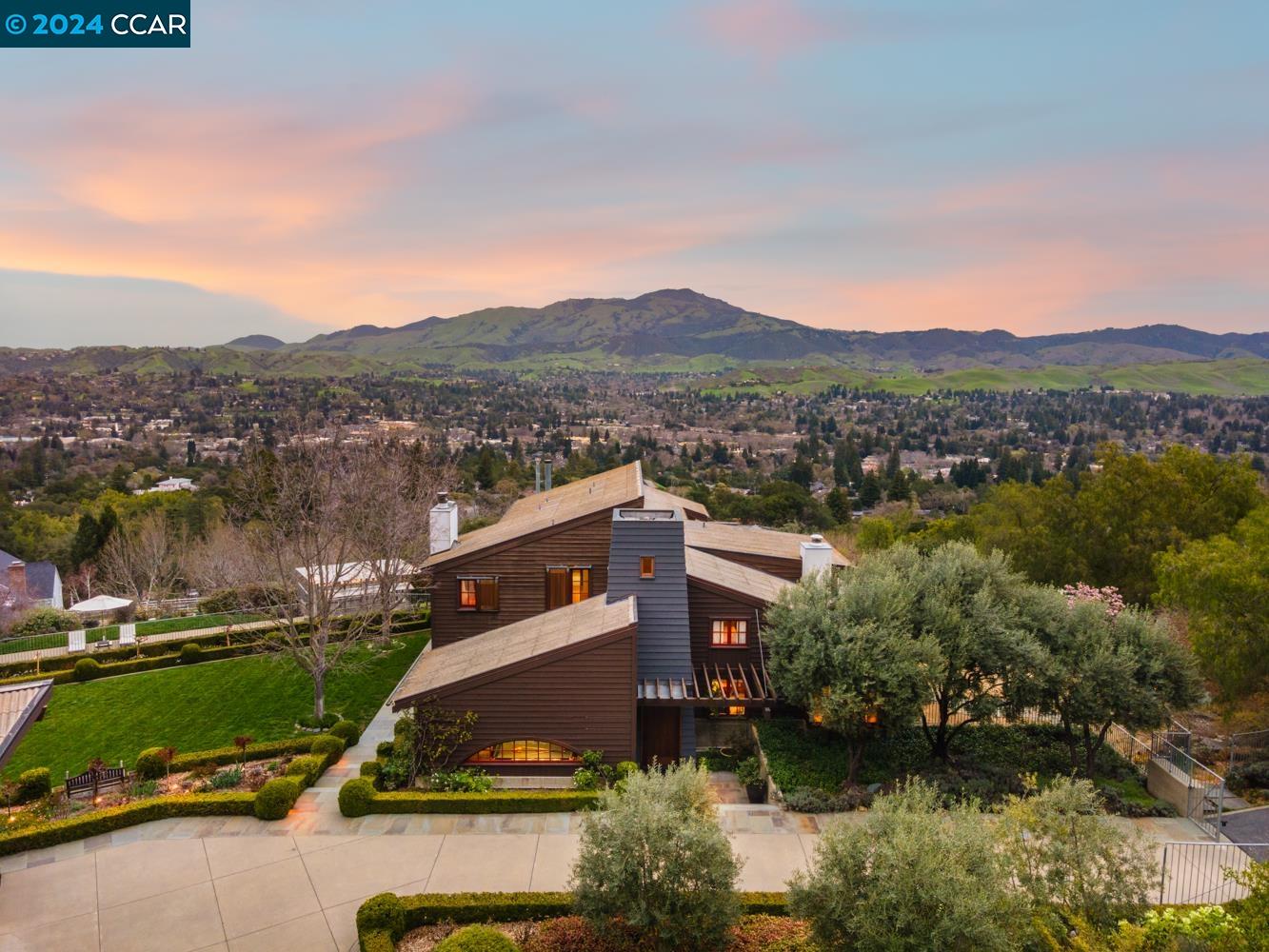 This Westside Danville, entirely custom-built residence transcends the ordinary. Nestled on 3.5+ acres & mere steps from Las Trampas open space trails, offering unobstructed views of Mt Diablo that follow you from room to room while the meticulously landscaped grounds attempt to steal the limelight. A blend of Modern, Craftsman & Mid-century styles - pine plank floors, plaster wall coatings, & exposed concrete offer grounded elegance. Clear cedar, Douglas-fir timbers, & heart redwood custom-milled exterior doors, windows, & interior paneling are used throughout. The main level offers a formal living room, formal dining room serviced through a butler's pantry, chef's kitchen with top of the line appliances, family room with panoramic views, billiards room & guest room/bath. Upper level is comprised of the primary suite, 2 secondary bedrooms with a shared hallway bath & a quiet library/loft. The final interior elements include a large, projector-ready home theatre, & a concealed but walk-in tech closet which serves every Ethernet, coaxial, telephone, & speaker cable in the house. Stepping outdoors, a pristine pool & spa with a dedicated bath house offer the perfect place to unwind & soak up the California sunshine. Welcome to 575 Highland Drive, an unreplicable legacy home!