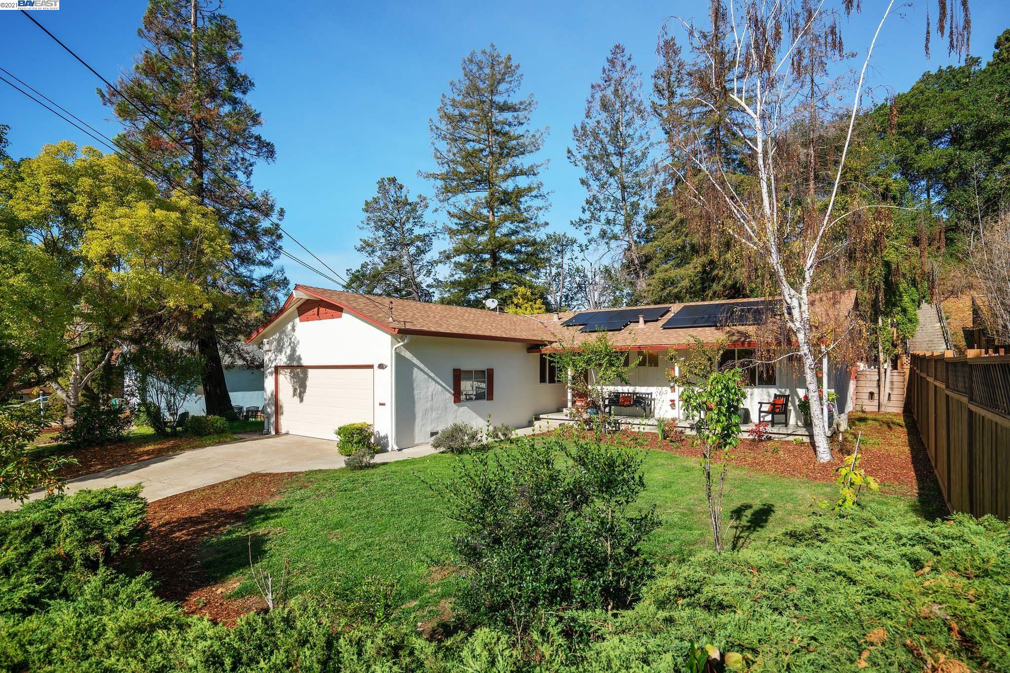 Resting in the Oakland hills Grass Valley neighborhood, surrounded by public  parklands, is this ranch-style 3 bedroom, 2 bath home, with a 2-car attached garage against a private hillside. Built in 1955 with quality construction, this home is approx. 1284 sq. ft. w/ a generous-sized 7625 sq. ft. lot. Ready to move in - freshly painted inside and out, beautiful hardwood floors that flow throughout the living room, dining area, bedrooms, and hallway. Energy efficient upgrades include: solar energy panels, dual pane windows, and a professionally installed vapor barrier. Also has a new garage door, 5-burner gas stove, dishwasher, vanity, toilet & bathroom floor. Surrounded by nature, it's located above Oakland Zoo & by Chabot Regional Park, Knowland State Arboretum & Park, Lake Chabot Municipal Golf Course & Sequoyah Country Club. Up the street is the Clyde Woolridge Staging Area (parking lot) w/ hiking trails to Miller Creek and the Upper San Leandro Reservoir. Easy access to 580.