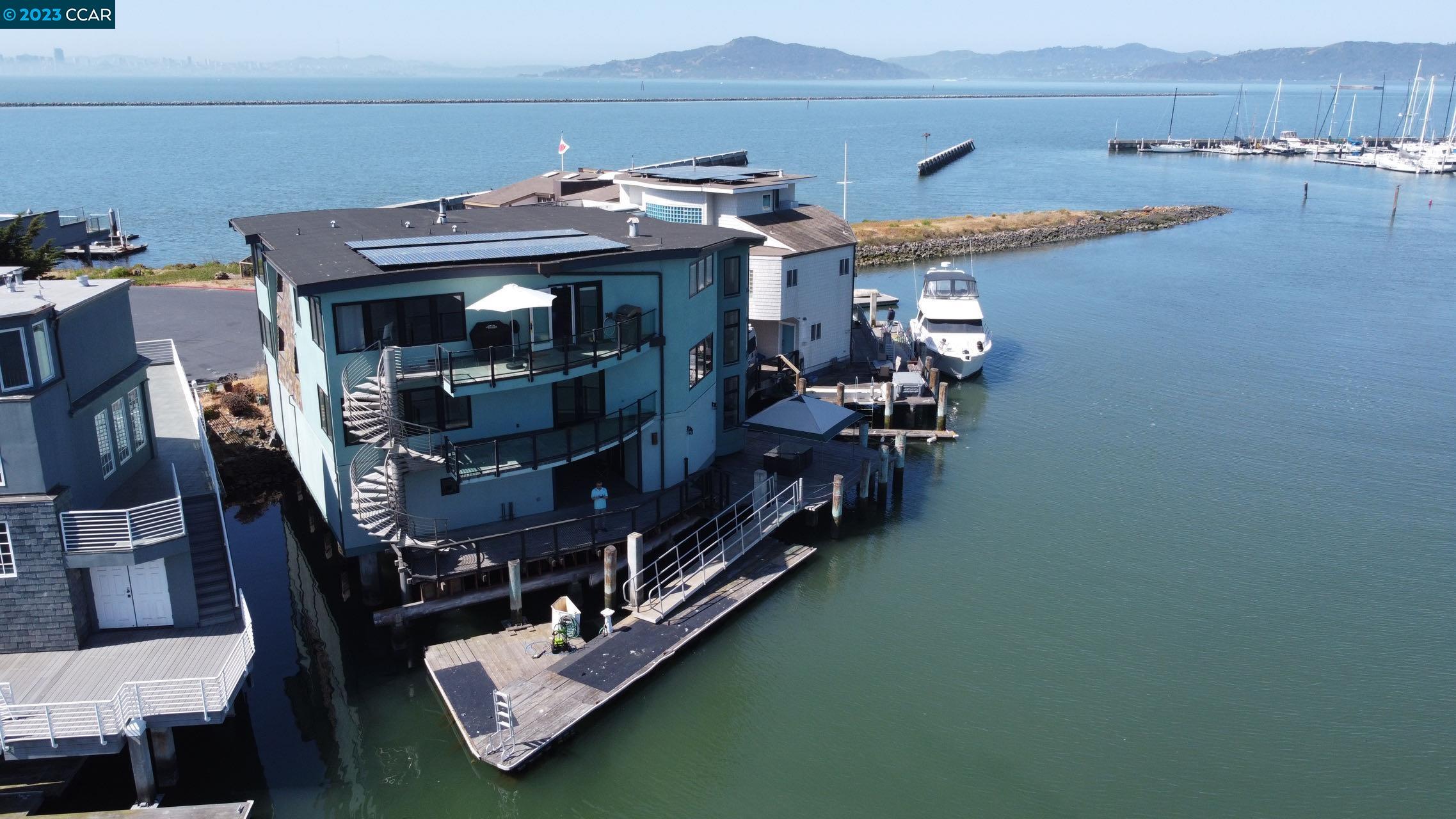 With Commanding 360-degree views of the San Francisco Bay, Bay Bridge and SF's Skyline from almost every room. This Luxurious waterfront masterpiece was built in 2005 and features a 55-foot boat dock with 104 feet of water frontage, 4 suite bedrooms + office and 2 partial baths, an open-concept chef's kitchen, expansive living room, additional recreation room and multiple outdoor living spaces perfect for enjoying quintessential waterfront living at its finest. The High-quality construction and attention to detail are obvious throughout every aspect including the concrete pilings and concrete deck which support the home, designed to withstand the test of time on the water. The home is ideally situated at the end of the cul-de-sac. Private elevator services all 3 levels which makes daily life much easier. This home 's striking, contemporary lines are visible from the water and echo the seafaring yachts which pass through the bay.