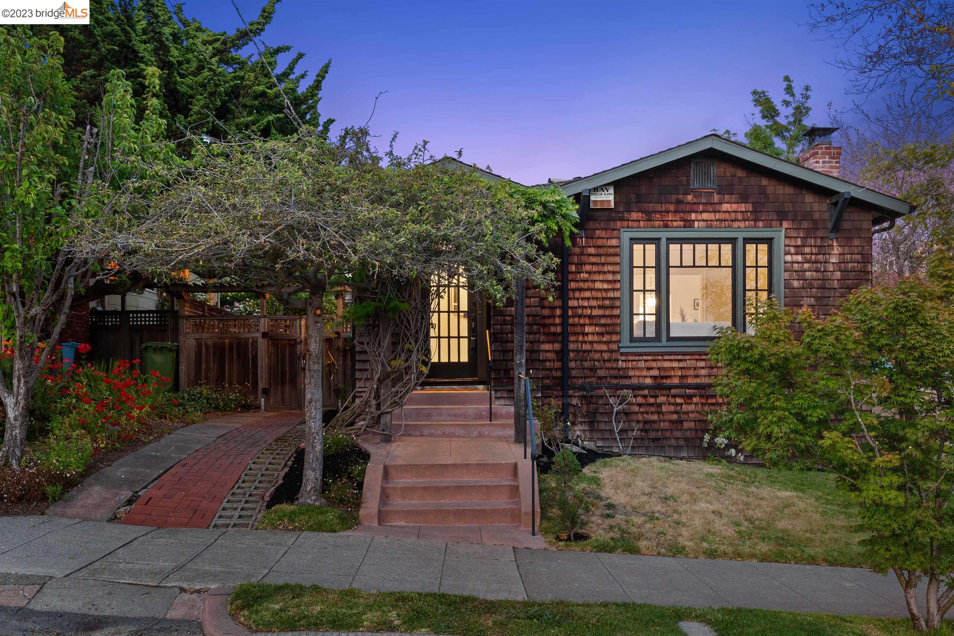 Owned since 1985 by Berkeley’s David Lance Goines, this charming 1923 brown-shingled craftsman is quintessential Berkeley! Inside, an abundance of original details, including oversized baseboards, picture trim moldings, and period light fixtures. Set on a corner lot & wrapped with a green lawn. The entryway is convenient for coats & keys. From there, wood floors & original windows add richness. The living room features a fireplace. Spillover from the living room to the dining room which has a fresh coat of paint paired with the original light & built-ins. Both bedrooms are served by a refreshed bathroom: new vanity, light & modern mirror. The shower has been retiled & the historic tile floors stay! A kitchen is as cute as can be— it’s minimalist in design, with maximum storage. While the Wedgwood stove is the star of the room, high-quality cabinets impress. Adjacent is a breakfast nook. The laundry room serves as access to the backyard as well as a pantry. In the yard, a deck, mature trees, foliage, old bricks & fountain statue. Has a finished garage; continue using it as an art studio or modify to park here again. Don't miss your chance to own a piece of Berkeley history in one of its most desirable neighborhoods, Northbrae.