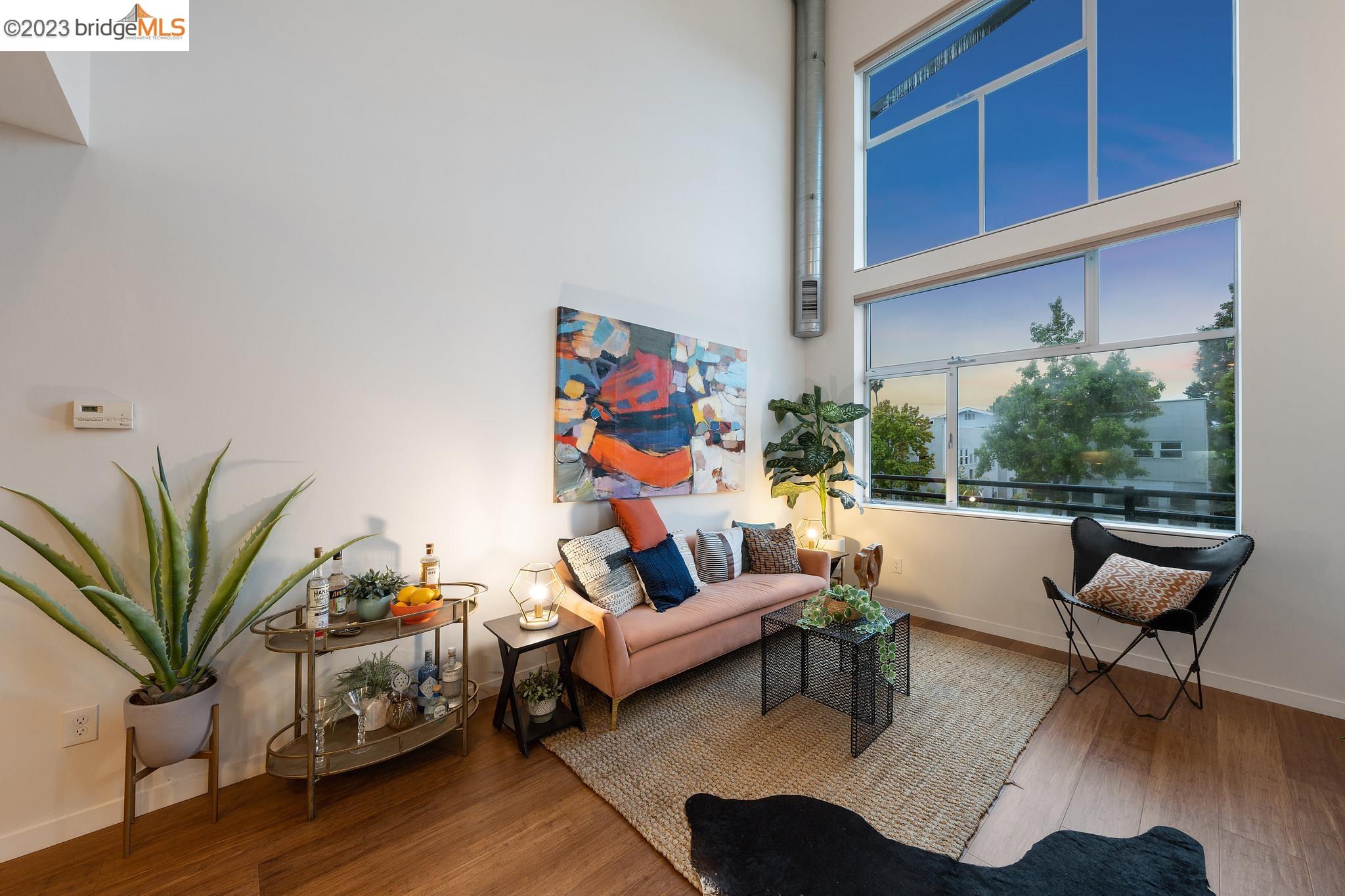 Light & bright loft-style 2 story living meets Berkeley’s Elmwood Loft. Built in 2006 w/ a 2023 designer refresh, this move-in ready space spans 1,102 SF w/ 2 bedrooms & 1.5 baths. Thoughtful layout w/ 1 bedroom & full bath downstairs, & an open loft & 2nd bedroom upstairs w/  1/2 bath & sliding door to balcony w/ Berkeley Hills views – perfect for a roommate setup or just for you. An open kitchen/living/dining concept w/ soaring ceilings & oversized windows beam in sunlight, complementing the industrial feel of the main level. In the kitchen, you’ll find all-new quartz countertops & stainless steel range, black cabinets & a dramatic quartz backsplash. New flooring, new plumbing fixtures in kitchen & bathroom sinks, new door hardware, new lighting throughout, a new kitchen pantry & updated bathrooms w/ new designer quartz countertops, mirrors, faucets, lighting & tile floors are among the upgrades & updates bringing the home into move-in ready condition. Additional features include in unit washer/ dryer, a detached private 1-car garage, a lobby for receiving packages & a common patio area for hanging out. 10-min walk to shops & restaurants on College Ave. 88 Walk score & 99 Bike Score make this condo a walker’s, cyclist’s & commuter’s paradise.  Run don't walk to see this one.
