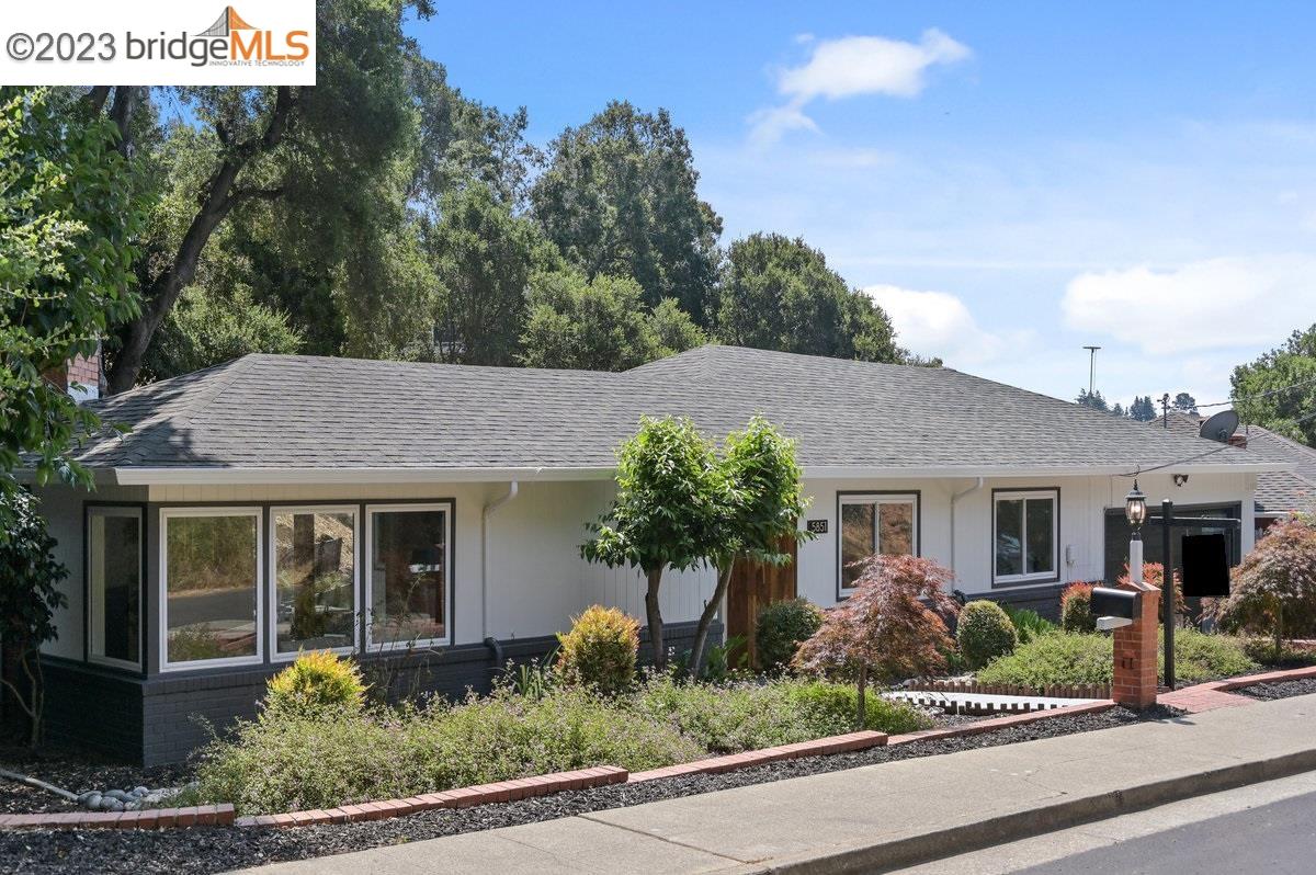 Indulge in this Mid-Century Charmer on a Tranquil Cul-de-Sac! Effortlessly enjoy level-in living, with a seamless flow from street to house to backyard. Boasting 3 bedrooms, a bonus room and 2.5 updated baths, including a luxurious primary suite, this home offers comfort and style.   Relish the warmth of the spacious living room with its updated fireplace, perfect for gatherings. The sunlit eat-in kitchen is a culinary oasis, adorned with abundant windows that infuse the space with natural light. Wood floors grace the main level, enhancing the classic charm.   A versatile bonus room downstairs, complete with a half bath, fireplace, and exterior access, provides endless possibilities - a 4th bedroom, an office or a family room, your choice.   The expansive level backyard is an entertainer's delight, with a playhouse adding a touch of whimsy. Parking is a breeze with a 2-car garage, a large driveway, and ample street parking.   Benefit from easy access to highways 13 and 580, making commuting a breeze. Explore nearby Leona Heights Park trails or satisfy your retail desires at the updated Lincoln Square shopping center, just 4 minutes away.   This mid-century gem offers more than just a home; it offers a lifestyle of comfort and convenience.