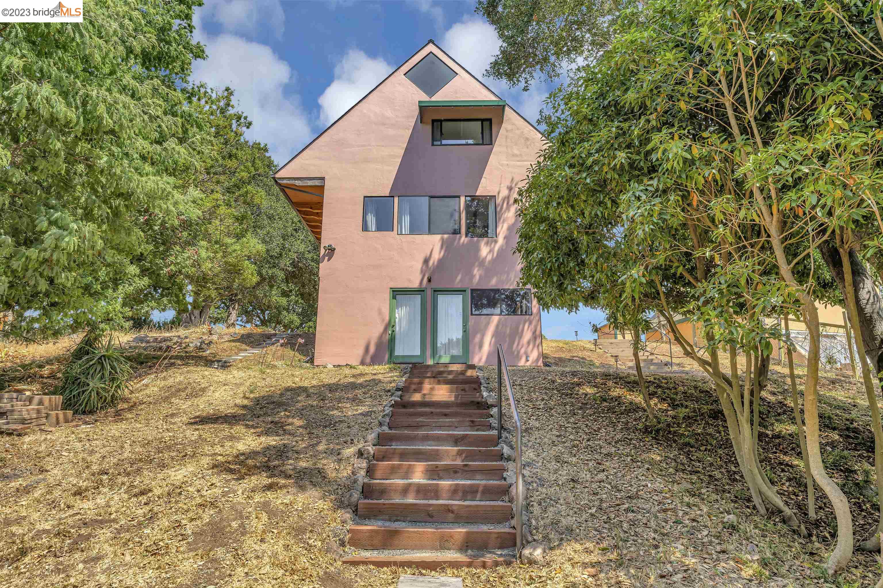 This unique, light-filled architect designed contemporary home on three levels was built in 1992. The top two levels have totally open floor plans, taking advantage of the incredible views of Wildcat Canyon Regional Park. The 6,600 square feet lot backs up to vacant land that backs up to the park, virtually making the park the backyard to this home. Newer flooring and other recent improvements have been made to the home. The main level has the kitchen and a huge open room. The upstairs has a huge open room, the main tiled bathroom with a skylight, closet, a loft and a fantastic view of the park. The downstairs was developed after the home was built with a large room, bathroom and kitchenette which is not reflected in the public record.The square footage is estimated from the floor plan from the photographer. There is also a laundry/utility room downstairs. The home, set back from the street, features an older two-car garage and a shed. ADU potential downstairs and/or garage. This is a super tranquil setting for the buyer looking for something very special.