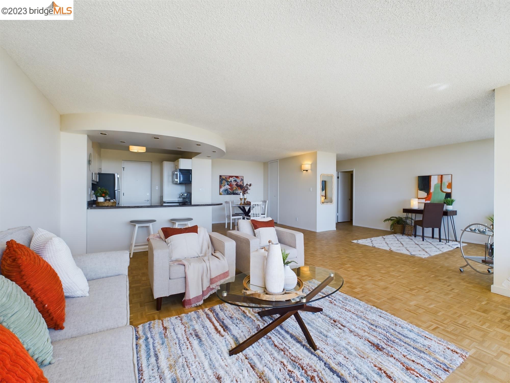 Located in the coveted, mid-century Van Buren Tower in the desirable Adams Point neighborhood of Oakland, this spacious, luxurious condominium is a rare gem. High above Lake Merritt on the 11th floor, this South-facing unit is open, bright, and filled with natural light. Enjoy the breath-taking, floor-to-ceiling views of the Lake, Downtown, the Bay, and even the Peninsula from every room.  The large living area, complemented by an ample balcony creates a seamless indoor-outdoor flow. It’s truly perfect for taking in the stunning sunsets, city lights, and broad high-rise views. The bedrooms, too, share their own balcony areas - perfect for a private read or relaxing moment. The unit also features a primary bedroom with a sizable en-suite full bath, a second bedroom and a second full bath for guests. The refreshed kitchen and baths; refinished white oak flooring; open layout; and generous storage make it ready to be your stress-free retreat!  Also offered at Van Buren, a gated garage with an assigned parking space; community, app- driven laundry facilities; electronically keyed and coded elevators; on-site additional locked storage; common area lobby and outdoor terraces; and gated bike storage. Plus, Van Buren Tower is pet- friendly and offers EV charging, too!