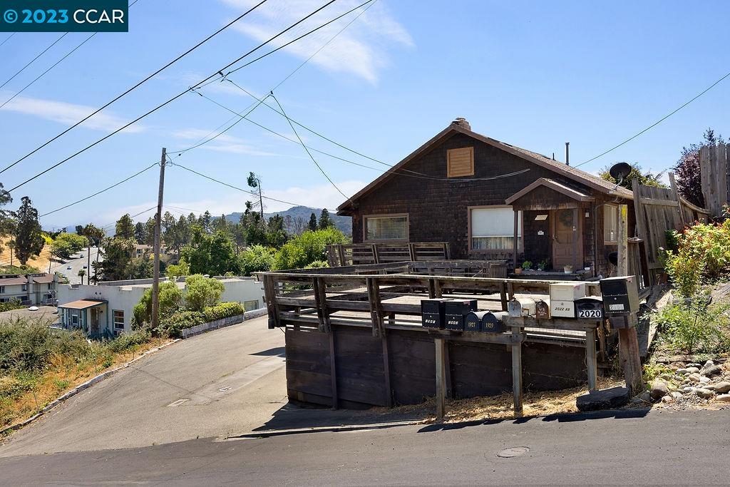 This lovely cottage has 2 bedrooms, 1 bath, and a huge wraparound deck to take advantage of its relaxed country setting. The possibilities for the 8,050-square-foot lot are endless. The entrance and front deck are elevated above street level, enhancing the feeling that you’re entering a rustic cabin among the trees. Inside this well-maintained home with charming period details, you will find a cozy living room with a wood fireplace and generous windows. The spacious kitchen has lots of warm, wood-faced cabinets that complement the tile floors. The bathroom is larger than you’d expect, and the primary bedroom features a slider that opens onto the deck. An attic offers extra storage space. The deck is the star of the property, stretching all the way around and accessed by sliders and French doors. It offers ample space for dining, a conversation pit, a container garden—you are limited only by your imagination. And there’s lots of flat ground in the oversized yard for landscaping or outbuildings. A 2-car garage features additional storage. You may feel like you’re in the country, but the neighborhood is close to shopping centers and major highways and less than a mile from K–12 schools. A quick drive gets you to Pinole Valley Park and Sobrante Ridge Regional Preserve.