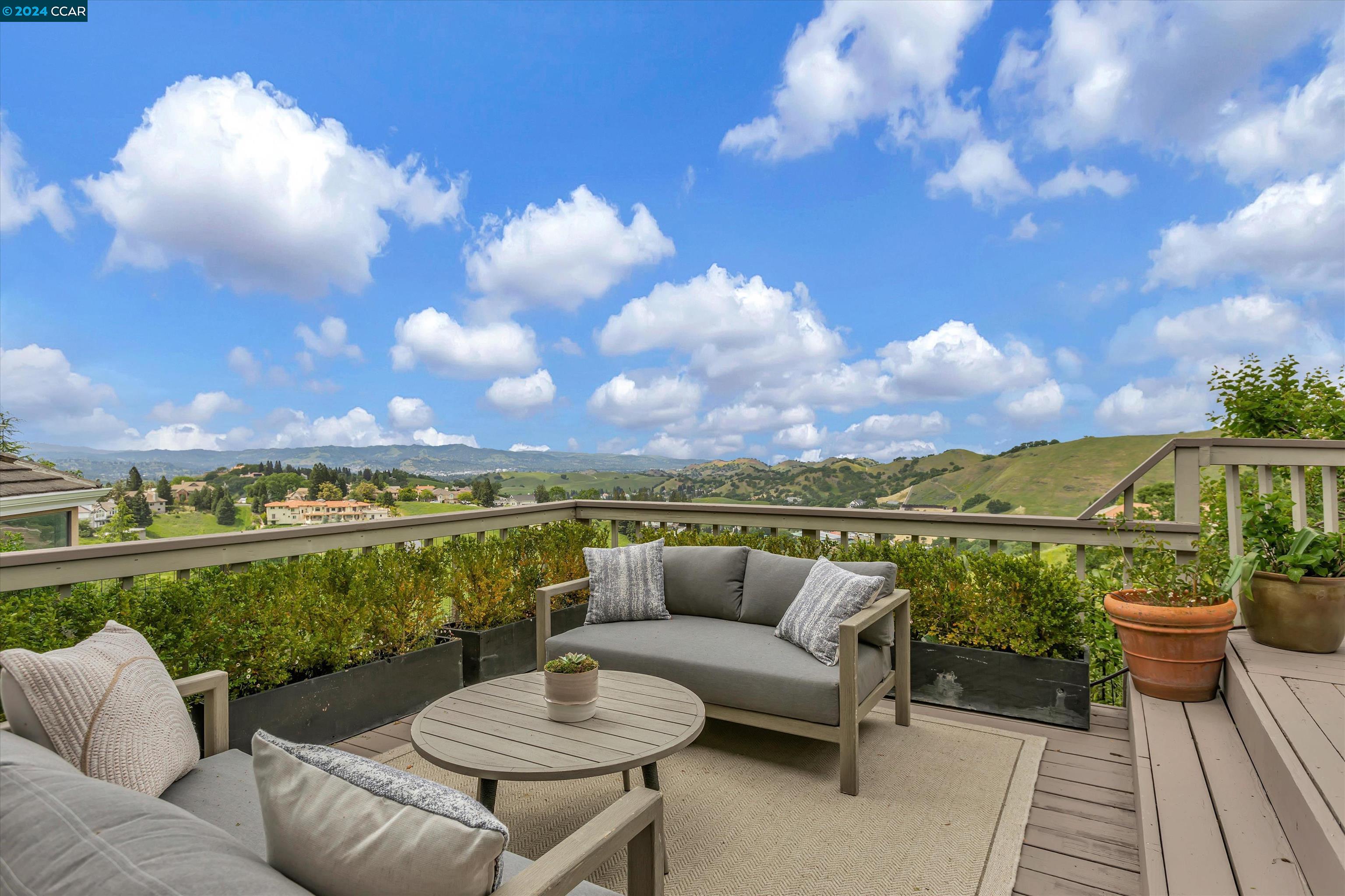 Nestled in the prestigious enclave of Round Hill North Estates, this elegant home offers captivating views & luxurious living. The home offers 4 bedrooms + formal library / office +separate gym, 2.5 baths w/approx 3,600 sqft. Entering into the bright foyer you are greeted by stunning views that will take your breath away! The living room showcases expansive sliding glass doors, accentuating the panoramic views, while a fireplace infuses the space w/warmth & refinement. The newly renovated kitchen features slab counters, SS appliances, breakfast bar & eat-in nook. The sunlit family room is complete w/soaring ceilings, fireplace & access to the wrap around deck. Downstairs library w/rich wood paneling & fireplace. Relax in the luxurious primary suite w/spa-like bathroom featuring stand alone tub, stall shower, dual sinks & walk-in closets. 2 additional bedrooms share fully renovated bath. Whether hosting al fresco gatherings or simply unwinding in the tranquility of the surroundings, this home offers it all & creates a space you will not want to leave. Close to Round Hill Country Club, hiking trails & top rated schools.