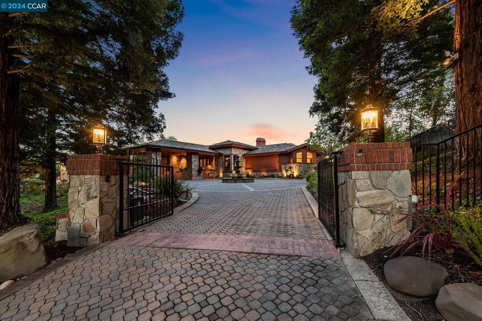 Grand, gated, architecturally impressive 1.2-acre Blackhawk estate designed by Young & Burton. Nearly $6 million in updated features/finishes. Attn to every detail. Panoramic hillside & 12th fairway of Falls course views. 7410+/-SF. Mostly single-level. 5 en suite bdrms inclds upper-level 2-rm suite. 8 bths incld 2 half bths & pool bth. Soaring exposed wood ceilings. Granite, wood, carpeted flrs. Andersen French drs. 4 frpls. Custom stained-glass entry, atrium, light-drenched int. Formal living & dining rms. Bar rm. Exec office. Redesigned eat-in chef’s kitchen. Dual Miele appls: ovens, microwaves, warming drawers, dishwashers.  Coffee station. SubZero full-sized frig & freezer. Cherry cabinets. Granite counters. Dual brkfst bars. Large fam rm. 800+ bottle wine cellar/tasting rm. Solar panels. Outdoor + caterers kitchen, granite counter seating. Pergola w/flatscreens. Pebble-tec pool & spa. Extended Ipe deck. Feeney railing. Slate patios. Lush garden bds, rose garden. 4-car garage, custom cabinetry, EV charger. Laundry w/dual stacked w/d. 3-zoned HVAC. Security cameras. Slate tile roof. Copper gutters/downspouts. Smart thermostats. Safe rm w/phone. Deer fencing. Near 2 golf courses, clubhouses, fitness ctr, tennis cts. Blackhawk Plaza, downtown, freeways, top-rated SRVUSD schls.