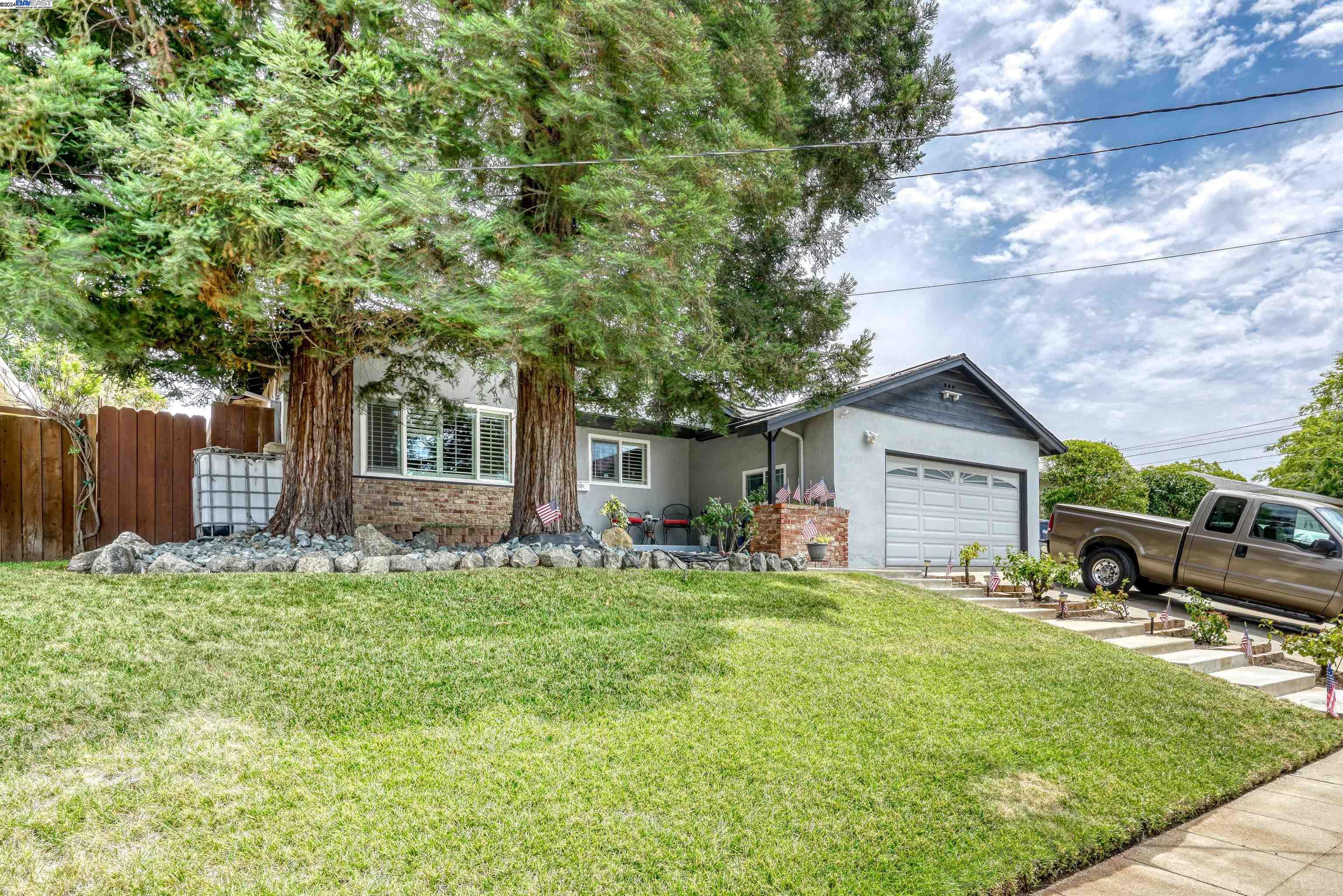 Sunset East beauty, spacious 4 bedrooms 3 full bathrooms, open floor plan with living-room, kitchen and family room flowing together all with hickory sienna distressed hardwood floors, tasteful remodeled kitchen with granite counter-tops, gas stove top, built in oven and microwave, and a dry bar.  Step down into a cozy family room with fireplace featuring a raised marbled hearth and surround, living room has additional marbled faced fireplace.  Extra large Master bedroom suite separated from rest of bedrooms, master bathroom features a step in shower stall, nicely tiled with a beautiful full glass shower door.  Slider in Master takes you to the oasis backyard with a pacific blue in ground  swimming pool.  Double pane windows throughout with shutters in the front rooms.  Hall bathroom features a soaking tub with tile surround and flooring.  Private bathroom located in another larger bedroom, with a shower stall. Crown molding in front rooms, with lots of details in this well loved family home.  Close to shopping, highway 84 and a jaunt to downtown Livermore.