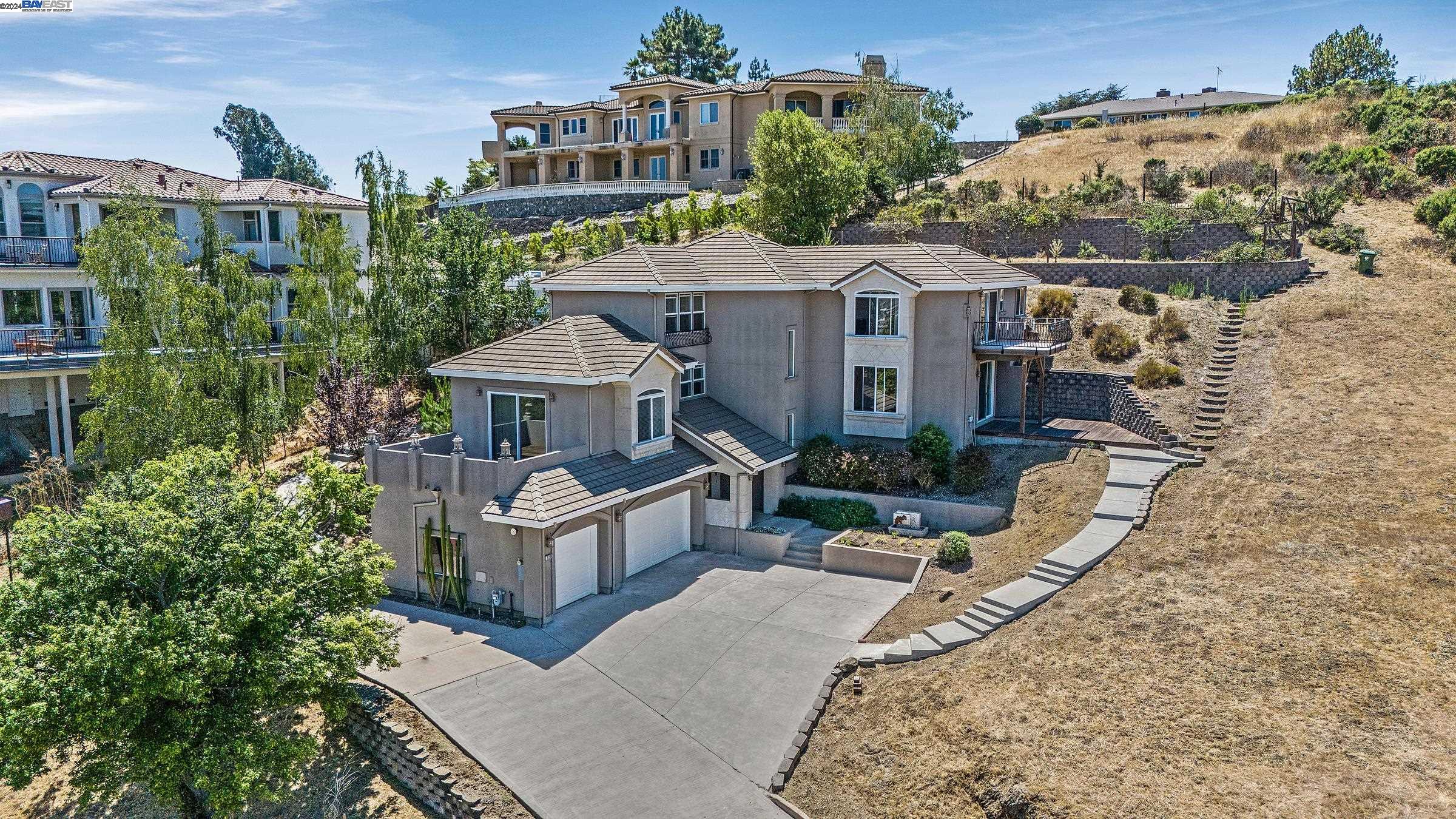Property was once three APN#'s that were combined into one.  See photos for a visual of the lot boundary. Just under two acres walking distance to Lake Chabot. Views of Lake Chabot throughout the home. Gourmet Kitchen. Free Standing Wolf Range and Hood, with four burners, griddle, grill, double oven, stainless steel.  Sub Zero Frig 48", 2 doors, with ice maker, stainless, with decorative grill. Wolf Microwave built in and warming droor. ASKO Dishwasher. Granite island 45"x93" with sink, outlets, cabinets and fully extendable roll out shelves.  Wood Cabinets throught with deep droors and roll out shelves.  Primary bedroom with  unobstructed views of lake Chabot and all of Castro Valley; gas fire place, balcony, walk in closet, a large bright bathroom featuring an enourmous tub, huge walk in shower, seperate counters and two sinks.  Two dining rooms, two family rooms, an office, and laundry room. Very clean, quiet and private. Two AC units and two furnaces. Three gas fireplaces, huge three car garage with tons of parking. Freshly painted with new carpet.  Three balconies and tons of space to manifest your dreams.  Located close to everything but feels like your miles from it all.  Potential for future development, subdivision and ADU.  Property is Virtually staged with AI software.