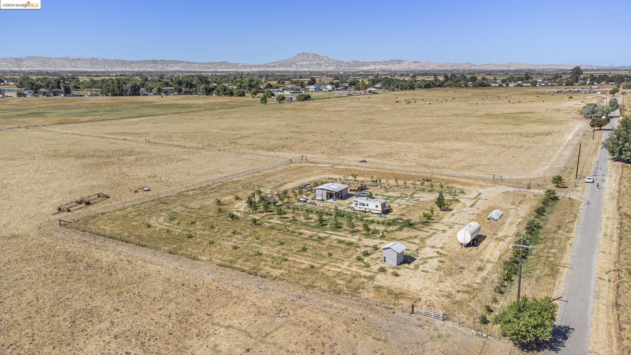 This is an opportunity for a developer to entitle this property to utilize for its potential allowed by the General Plan. There is mixed zoning on this parcel. The frontage on bethel Island Rd is Commercial that's 500 ft. of Commercial frontage. The Commercial portion is approximately 2.5 acres in total. The back section of the property is zoned agricultural. With all the development in the area including 1000's of homes coming on Bethel Island and Cypress Rd. This will be a great piece to hold and or develop. Please Check with Contra Costa Planning for any of your development questions. Owner has planted overt 100 Trees in a fenced section at the back of the property. These include Plums, Dates, Persimmon, almond, pecan, peach, cherry, Fig, and apricot. In this section there is a well 280 Ft deep. also seller has set up irrigation for the trees feeding from a 7500 gal storage tank.  Information provided to be confirmed with County Planning
