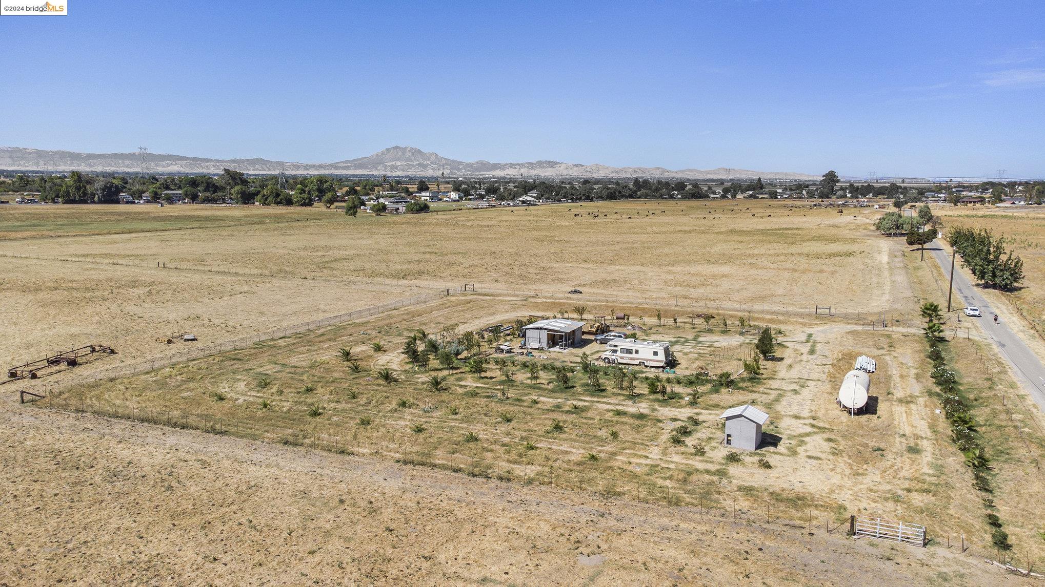 This is an opportunity for a developer to entitle this property to utilize for its potential allowed by the General Plan. There is mixed zoning on this parcel. The frontage on bethel Island Rd is Commercial that's 500 ft. of Commercial frontage. The Commercial portion is approximately 2.5 acres in total. The back section of the property is zoned agricultural. With all the development in the area including 1000's of homes coming on Bethel Island and Cypress Rd. This will be a great piece to hold and or develop. Please Check with Contra Costa Planning for any of your development questions. Owner has planted overt 100 Trees in a fenced section at the back of the property. These include Plums, Dates, Persimmon, almond, pecan, peach, cherry, Fig, and apricot. In this section there is a well 280 Ft deep. also seller has set up irrigation for the trees feeding from a 7500 gal storage tank. Information provided to be confirmed with County Planning