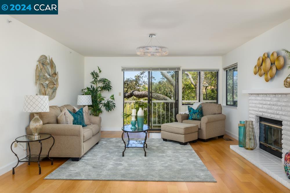 Popular Deer Highlands Redwood model offering beautiful tree and hill views from a generous balcony, in Rossmoor's 55+ active, adult community! Gorgeous finishes throughout this updated 2 bed/2 bath end unit which boasts nearly 1600 sq. ft, with an office, den or bonus room and two-way gas fireplace shared with a formal living room.  Enjoy views from every dual-pane window; a spacious, updated kitchen with beautiful granite counters and a gas cooktop, stainless steel appliances, lots of cabinetry and a breakfast nook; wood floors throughout make for a seamless flow; and natural light creates a warm and inviting ambiance. Large detached garage, and ample guest parking. A truly special home you’ll cherish!