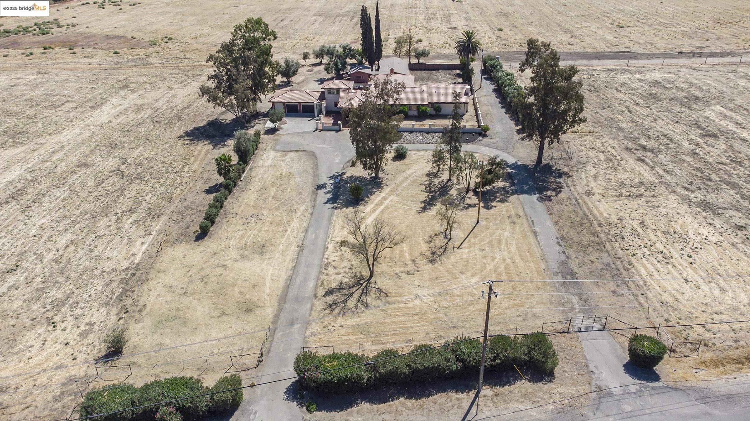 Don't miss your opportunity to own 18 acres directly across from Discovery Bay with multiple outbuildings and endless possibilities!  You will be captivated as soon as you enter the beautiful courtyard, featuring a stunning water feature and retractable ceiling. From the courtyard, enter the completely updated home featuring original antique leaded glass windows, an expansive open concept living area, and luxurious primary retreat with his and her walk-in closets, soaker tub and fireplace. On the opposite side of the courtyard is a private bedroom with ensuite bathroom and an upstairs bonus room. Pet bath in laundry rm. The property features a massive pole barn and 2,500 sq ft enclosed barn with concrete floor, tack room & 12 ft tall roll up door. Other structures include a detached unit with kitchen and sauna that, with a little TLC, could become an excellent rental or guest suite. 3 zone AC & furnace. New septic tank.  Zoned agricultural, boat storage and solar generation.