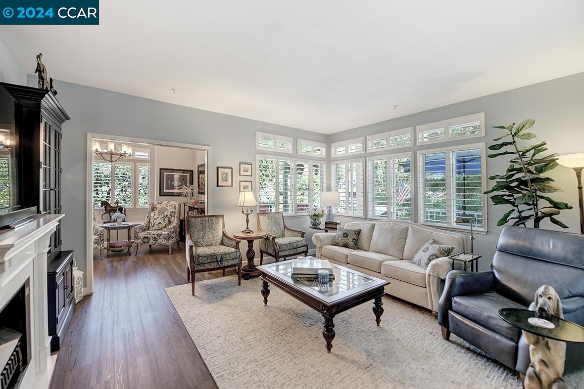 Step into stately elegance with this beautifully upgraded home featuring a stunning living room and luxurious primary ensuite with pitched ceiling. The living room with high ceilings has been thoughtfully re-designed with plantation shutters, crown molding, and removing the original fireplace, creating a seamless flow that invites relaxation and entertaining. Imagine sipping coffee on the expansive deck, with serene seasonal views of the vegetation and golf course. Golf Cart also available for sale. The home is painted in a soothing blue-grey palette, offering a calm inviting atmosphere. Garage boasts is in the building next to the unit with back door access close to front entrance of condo and has an extra storage loft perfect for maximizing space. Enjoy this and Rossmoor, a lively community where you’ll find an array of activities and amenities to suit every interest—from golf and tennis to pickleball and bocce ball, and from bridge and Mah Jong to art and ceramics… Embrace this moment and make this welcoming community your new home.