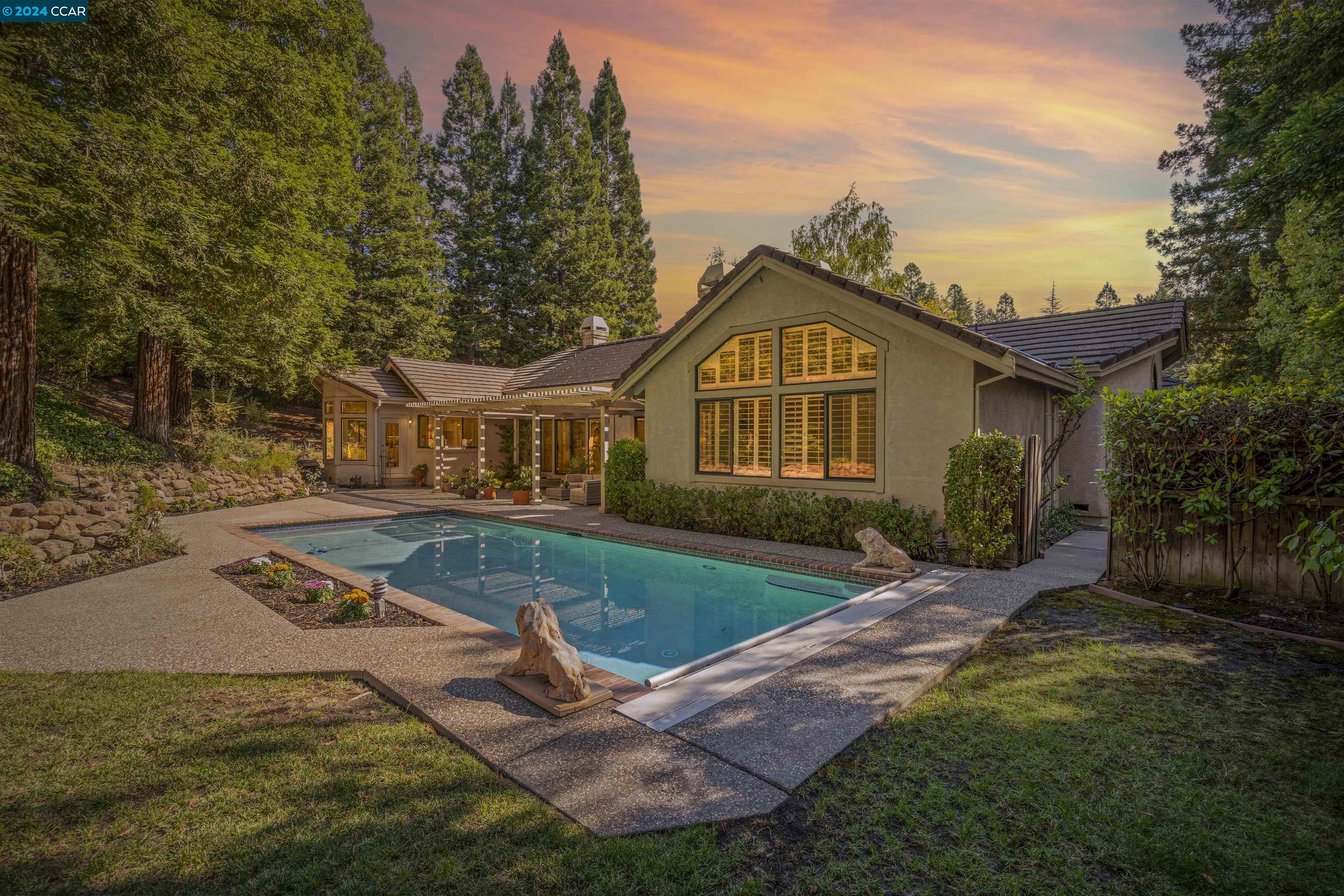 Welcome to 3353 Deer Hollow Drive! This exquisite single-story residence boasts nearly 3,800 sqft. of living space, providing the perfect canvas for your personal vision. Nestled on nearly half an acre of lush grounds within the prestigious Blackhawk Country Club, this home seamlessly blends luxury living with an exceptional lifestyle. Inside you’ll discover 5 spacious bedrooms and 3.5 bathrooms, perfect for families & entertaining guests. The expansive private wing of the oversized primary suite includes a cozy fireplace and views of the sparkling pool and hillside, creating a luxurious retreat. The heart of the home is a beautifully designed kitchen, complete with white cabinetry & elegant granite countertops. Generous living spaces abound, featuring a large dining room, an inviting living room, & a cozy family room—all designed for gatherings and creating lasting memories. Step outside and experience the beauty of the outdoors. Surrounded by majestic redwood trees, offering a tranquil escape with a sparkling pool while the property backs onto peaceful open space, framed by rolling hills that enhance your sense of privacy. Located in one of the East Bay's most coveted communities.Don’t miss your opportunity to transform this dream property into your ideal retreat and lifestyle.