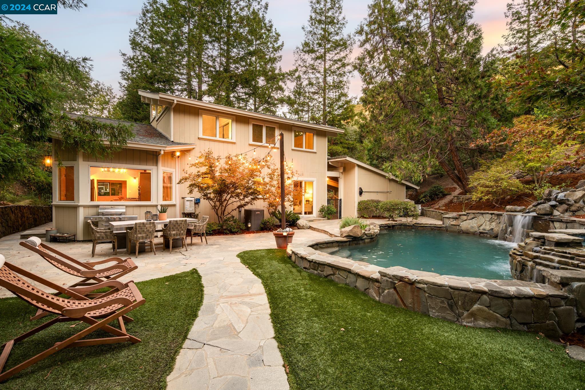 Enjoy the best of both worlds with this stunning Tahoe-style country home, ideally situated on the border of Walnut Creek/Alamo, minutes from downtown. Sprawling 1.24-acre lot surrounded by majestic oak & redwood trees, this private retreat in serene, natural setting. Vaulted ceilings & exposed beams create openness, abundant windows fill the space w/ natural light. Inviting great room features a wood-burning stove. The spacious kitchen boasts a breakfast bar, gas range, ss appliances, custom lighting & a large dining area. On the main level, you’ll find the primary bedroom, office, full bath, & convenient laundry room. Upstairs, a charming loft area, two additional bedrooms & full bath. Outside is a stunning stone-ridge heated pool & natural waterfall. Sitting area offers a peaceful spot to relax, while a finished detached shed w electricity provides a space for workouts, hobbies, or extra storage. This property also includes a fully separate ADUw/ its own entrance & driveway. The ADU features one bedroom, one bath, a full kitchen, laundry room, and ample living space—perfect for guests, extended family, or rental income. Located just minutes from vibrant downtown Walnut Creek, Downtown Danville, freeways w/ easy access to parks, shopping, & top-rated schools.  Sqft includes ADU