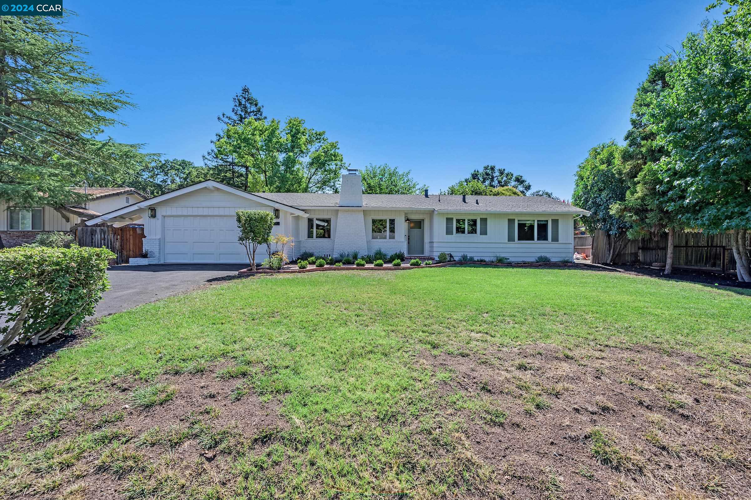 Stunningly remodeled Westside Danville rancher originally built by Harold Smith. Serene court living on a majestic .44 acre lot offering ultimate privacy in a park like setting. Beautiful curb appeal welcomes you and sets the tone for the entire home. Featuring 4 bedrooms, 2 bathrooms, and exquisite designer updates throughout, this home will take your breath away. Expansive living room has vaulted wood beam ceilings, brick fireplace and tons of natural light. The perfectly appointed chef’s kitchen boasts two tone shaker cabinetry, black soapstone countertop island with reeded back paneling and breakfast bar, Monogram 6 burner gas range with griddle and dual ovens, wine fridge, and eat-in kitchen nook. Impressive designer details in every bedroom including wainscotting, chandeliers and light fixtures. Spectacular guest bathroom uniquely styled with intricate pattern and color mixing with dual vanities and a vertically tiled shower over tub. Primary bedroom hosts a distinctive light fixture, a sliding glass door to the yard and has a spa-like ensuite bathroom. The sprawling, private backyard oasis is perfect for entertaining or for endless hours of relaxation. Phenomenal location in close proximity to downtown Danville, Iron Horse Trail, Hap Magee Park and top rated schools.