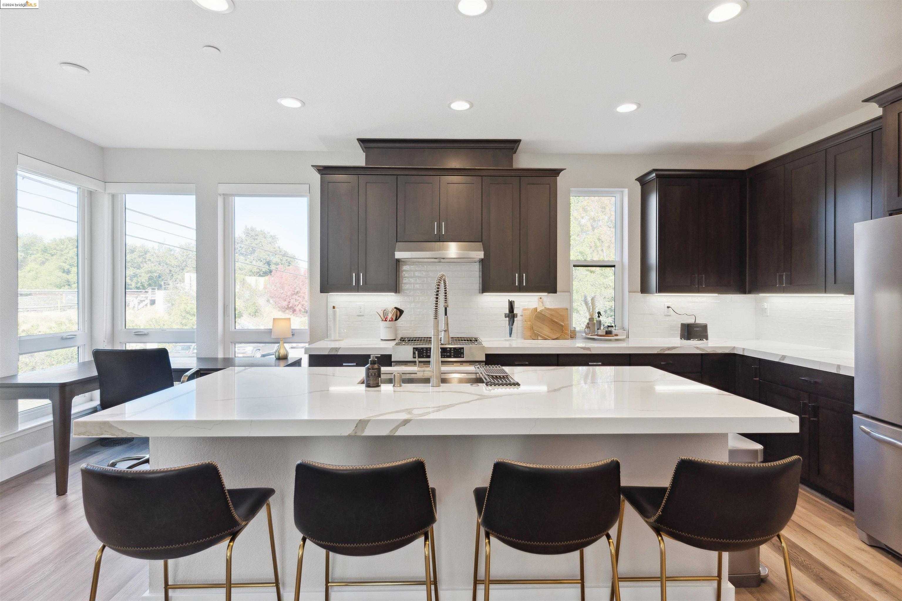 Must See! This home has given us the lifestyle we've always dreamed of. Modern design by Studio 81 International and custom built in 2021 by Mark ScottConstruction. On the ground floor, you're welcomed by a front patio, foyer with split A/C, 1 of 2 half baths and a 2-car garage w/ storage closet. The second floor's high ceilings and tall windows give TONS of natural light - especially being the end unit. Custom window coverings throughout, with motorized blinds in living, dining and primary bedroom. One of our favorite features is the accordion patio door that completes the open flow from kitchen to dining to living space, with a real pantry and perfect half bath for guests. All 3 bedrooms are on the top floor, with the primary + en-suite on one end of the hall, laundry closet, then the 2 bedrooms on the other end, all with custom closets. The primary en-suite boasts a double vanity, storage closet, nook and beautiful walk-in shower with bench. Seconds to the Contra Costa Canal trail, minutes to Downtown Walnut Creek, Broadway Plaza (outdoor mall) and easy access to 680 make the location ideal for wherever you are in life.