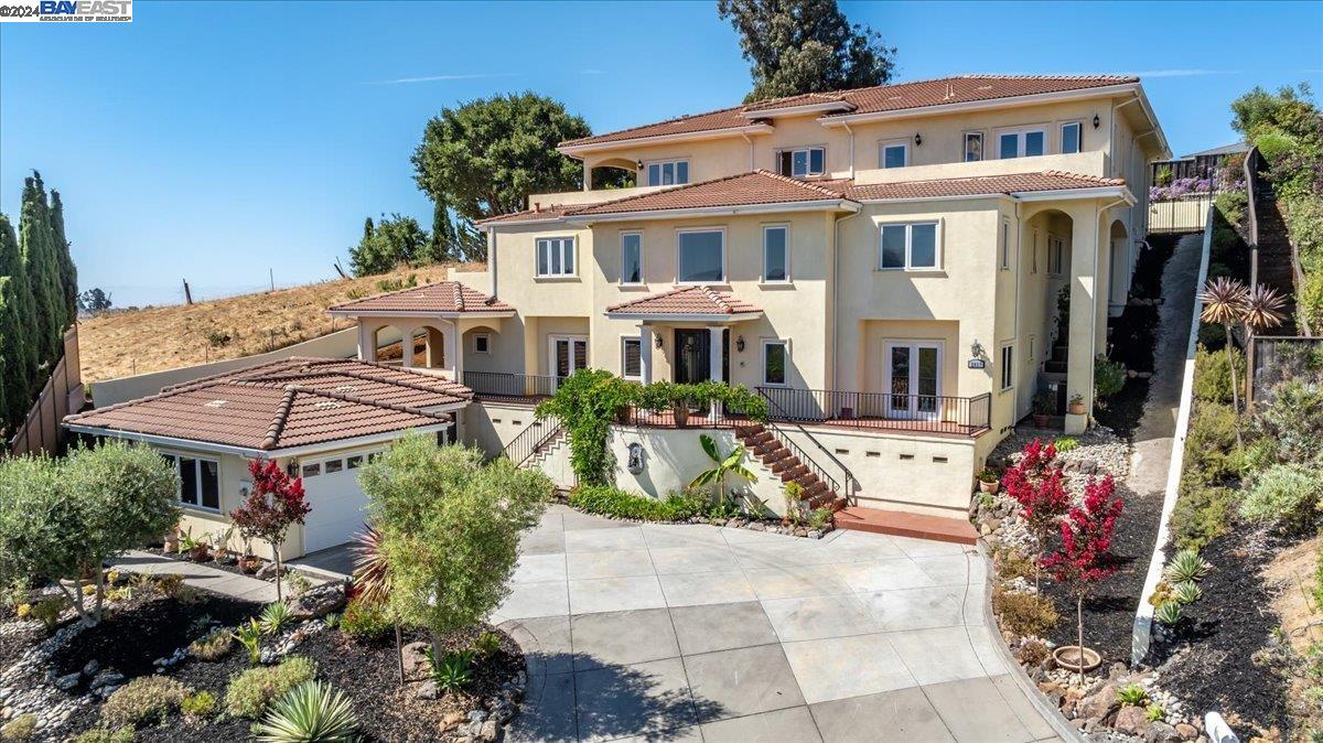 Welcome to luxury living at its finest in the prestigious, gated community of Chabot Estates. This expansive 5,515 sq.ft. residence epitomizes elegance & sophistication, featuring a grand entryway with intricate wrought iron railings that gracefully frame 2 sweeping staircases & landings. Which also includes a dedicated space for an elevator. Offering 7 spacious beds, including 4 en-suite beds & 2 beds share a Jack & Jill bath, making this home perfect for a growing family or hosting guests. Chef's kitchen is a culinary dream, equipped w/ SS appliances, including a double oven, 6-burner gas range w/ grill top, 60" refrigerator, dishwasher, sink, & microwave. The open-concept design seamlessly connects the kitchen to the dining area & family room, creating an ideal space for entertaining & everyday living. The opulent master suite features a balcony with stunning views & a spa-like bathroom. Indulge in the large soaking tub, dual vanities, & the privacy of 2 toilet rooms.The walk-in steam shower, equipped w/ multiple shower heads. Large windows throughout capture breathtaking panoramic views creating a picturesque backdrop to your daily life. Step outside to the tranquil backyard, where endless possibilities await. W/ extensive patios throughout to design your outdoor dream space!