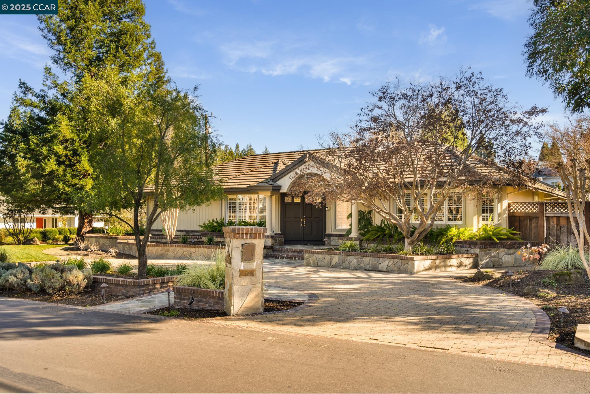 Located in highly sought-after Westside Alamo, this stunning corner lot home lives like a single level with a thoughtfully designed second-level suite with a kitchenette and balcony, providing a private retreat ideal for guests or extended family. Discover the gorgeous wainscoting that spans throughout, with new carpet and freshly painted interior. This floor plan flows seamlessly from the formal living room to the formal dining room and the chef's kitchen opens to the spacious family room. The fabulous kitchen is equipped with 3 sinks, center island, and built-in appliances including SubZero refrigerator, wine fridge, dishwasher including an additional drawer dishwasher and Thermador stovetop. Unwind in the cozy yet spacious primary bedroom suite with a separate office, fireplace and a spa-like bath with a large walk-in closet, dual sinks, and radiant heat floors. The newly landscaped backyard is an outdoor oasis with a sparkling pool/spa, BBQ grill and spacious patios including a courtyard for easy al-fresco dining. Located near downtown Alamo, the popular Iron Horse Trail, within the award-winning San Ramon Valley school district and minutes from downtown Danville.