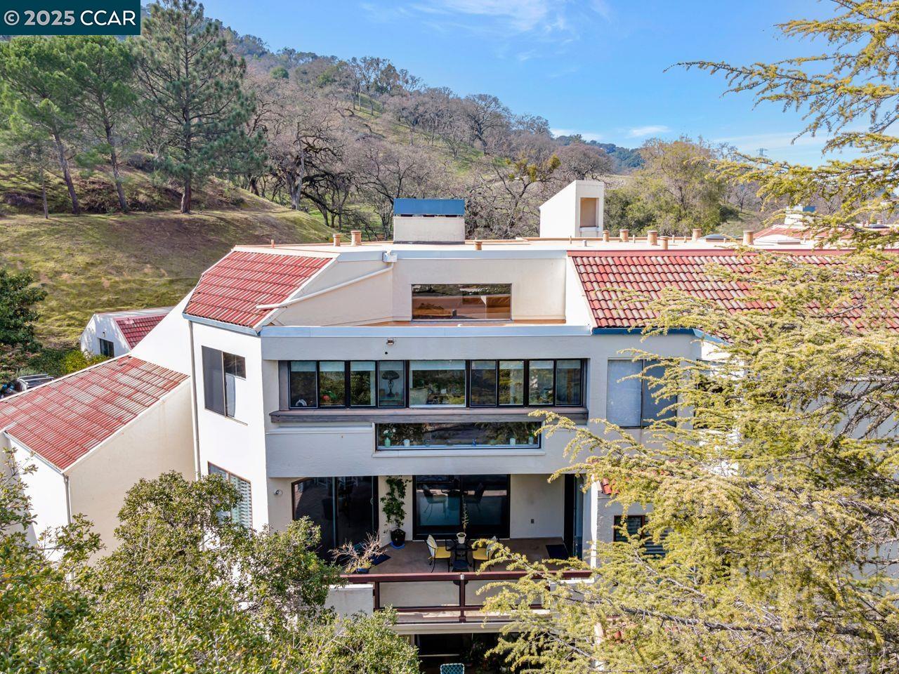 This beautifully appointed end unit is ready for its new owner. Dual-paned windows allow abundant natural light and offer stunning views of Mt. Diablo. This gorgeous Villa Robles model features many updates throughout, including a recently renovated kitchen equipped with cafe appliances, a farmhouse sink, a wine refrigerator, and a large breakfast bar that opens to the living area and offers a breathtaking view. Additionally, an expansive patio is accessible from the living room, primary bedroom, and dining area. The bathrooms have also been updated. A second bedroom with a Murphy bed accompanies the spacious primary suite.  An office loft, complete with permits, includes a large storage area. This unit also has an attached garage and elevator access, eliminating the need for stairs. The trailhead to walking hiking trail at the end is near guest parking, and all of this is in the Rossmoor Active Adult community!
