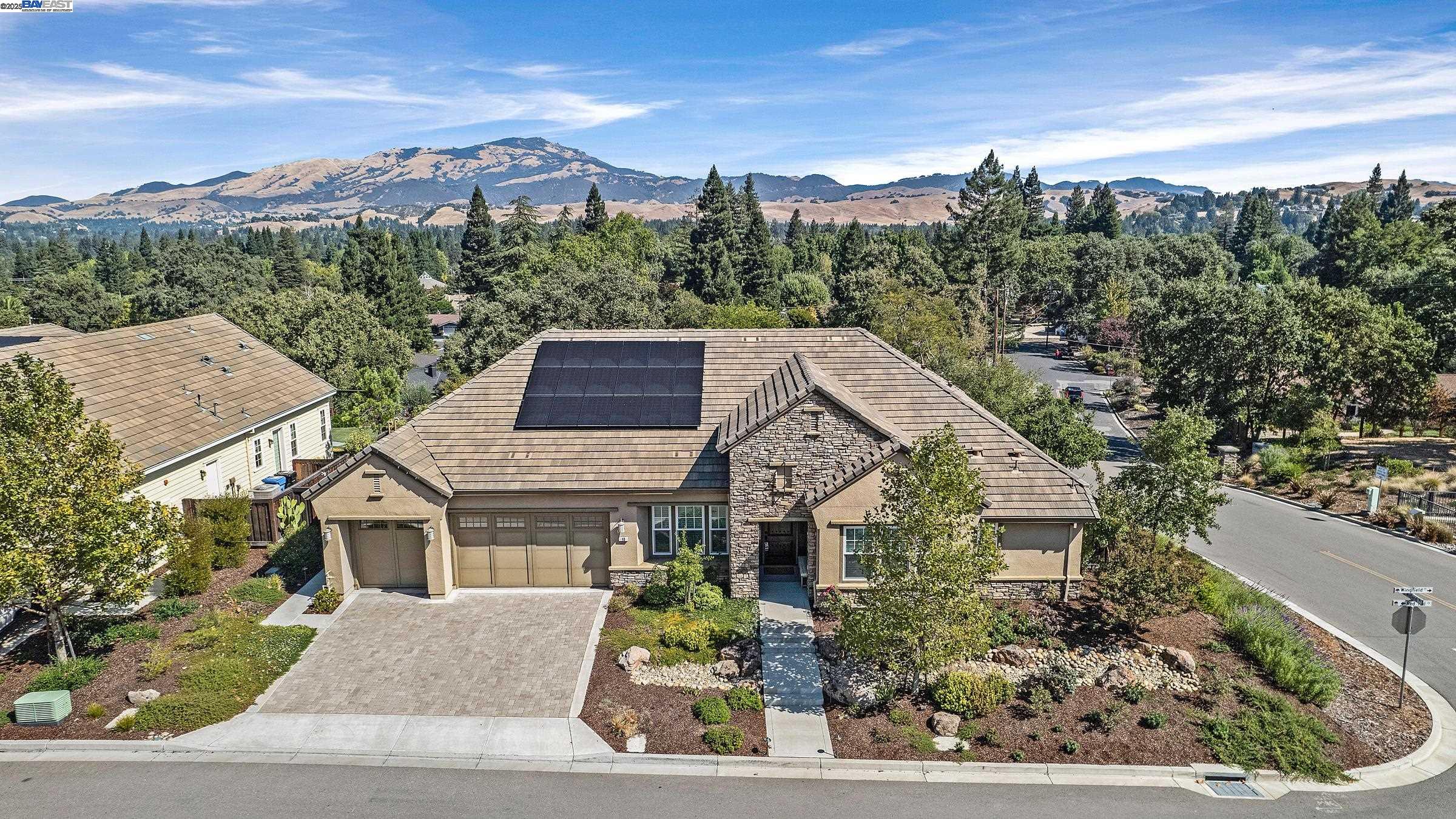 Built in 2019, this stunning single-story home is nestled in the highly sought-after Westside of Danville. Situated on a prime lot, the property boasts breathtaking mountain views. The bright and open kitchen is a chef's dream, complete with a large center island, bar seating, a walk-in pantry, and premium appliances, including a high-end gas range with double ovens, refrigerator, and dishwasher. The kitchen flows seamlessly into the expansive great room, highlighted by a cozy gas fireplace and panoramic sliding glass doors that open to the backyard with incredible views. The spacious master suite offers a luxurious en-suite bathroom with a soaking tub and a generous walk-in closet. Each additional bedroom comes with its own full bathroom, ensuring privacy and comfort for family or guests. The backyard is an entertainer’s paradise, with gorgeous custom finishes, including a tiled California Room and a built-in outdoor kitchen. Additional features include owned solar panels for energy efficiency. Located close to downtown Danville’s vibrant shopping, dining, and entertainment options, with easy access to Highway 680, this home offers the ultimate in West Danville.