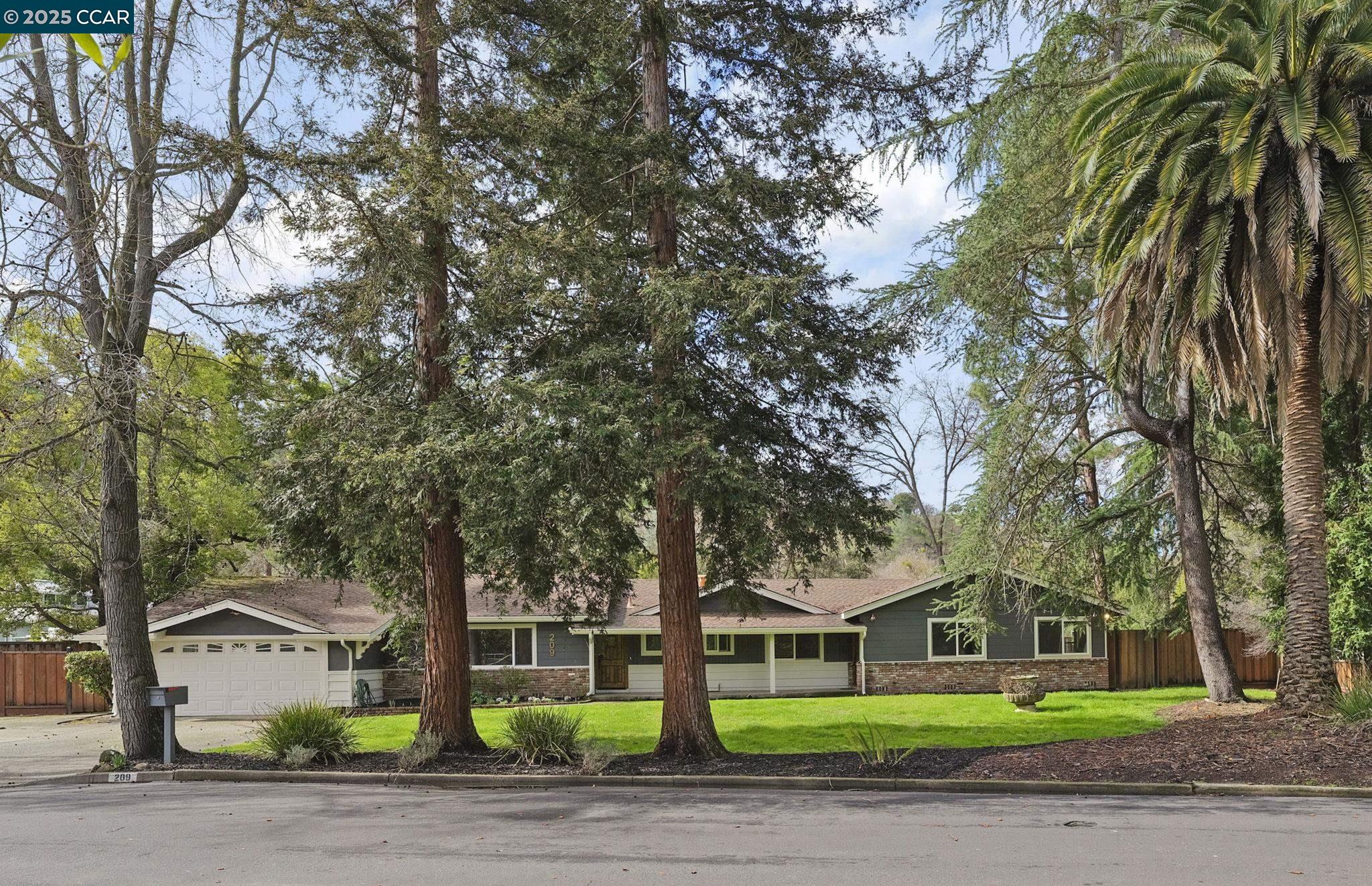 SPACIOUS SINGLE-LEVEL living in sought-after Tice Valley! This classic, ranch-style home features a wooded setting of beautiful, mature trees on a large, level lot.  The home has over 2500 SF of living space, 4 bdrms (including 2 ensuites!), and 3 full bathrooms. The interior offers 2 spacious living rooms and a chef’s kitchen with stainless steel appliances, an island for extra counter space and bar seating, a classic Wolf range, sleek quartz counters and a relaxing view of the private yard. The primary suite will “wow” you with its vaulted ceilings, large sitting area, 2 closets and a spacious new bathroom. A second ensuite features a private entry, making it perfect for an au-pair, an in-law or a home office. Additional updates include new wood flooring, new paint and chic lighting. Set on a large, flat lot with easy-care landscaping, this property offers endless possibilities for outdoor living, gardening, and entertaining – including an outdoor kitchen and fire pit. The neighborhood is extra-special too – just stroll along the quiet street and see for yourself! With top-rated schools nearby, easy access to commuter routes, and super-close to WC's vibrant downtown, this home is a rare find in one of the area’s most coveted communities.