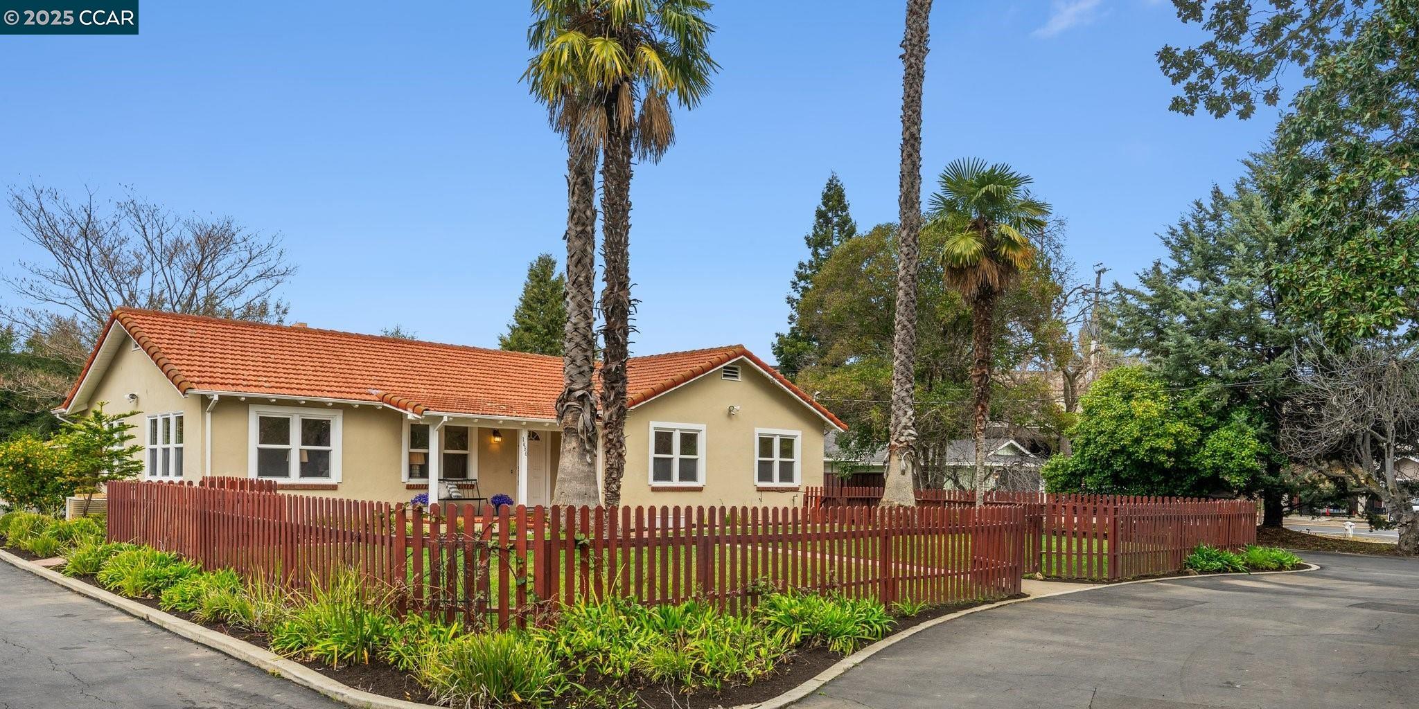 Open SUN 1-4! Nestled in the desirable Parkmead neighborhood, this exceptional, meticulously maintained home is conveniently set back from Newell Ave. behind majestic palm trees & lush lawns! Boasting an enchanting Spanish ambience and inviting covered front and back porches, this gleaming home is bathed in natural light! The living room & formal dining rooms feature rich hardwoods & sunny walls of windows looking out to the lush garden setting. This property features many fruit trees (Meyer lemon, navel oranges, & olive trees) on its sprawling .60 acre level lot, The private setting features outdoor spaces for gatherings with family & friends, gardening, home expansion possibilities, ADU and potential lot split/SB9 opportunities! Spacious kitchen with slab granite counters, wood cabinetry, recessed lighting, and French doors opening up to the covered back patio. In-house laundry closet, designer lighting, and a multipurpose 575 sq. ft. finished basement with additional living space and storage. In addition, there is a 160 sq. ft. detached office in the back: perfect for a craft or hobby room, additional storage, or home office space. Large detached two car garage with attached carport, and ample off-street parking space with a circular driveway! Just steps to downtown!