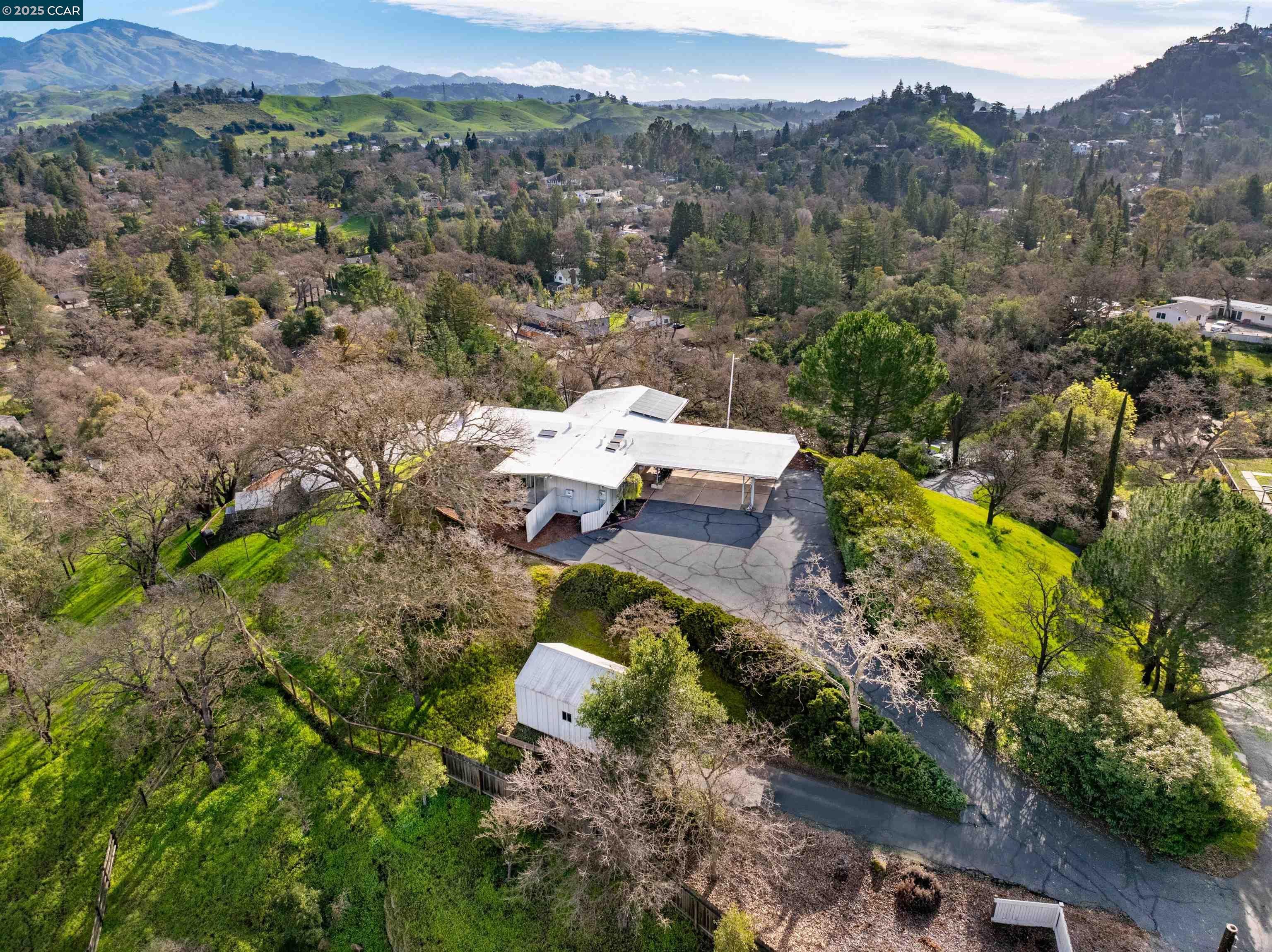 Are you looking for a single  story home with good bones on a premium lot in a good neighborhood? Come experience the serenity, privacy and exhilarating panoramic views of this home. Walk inside to a very Livable Floorplan with Tile Entry, New Carpet, New Luxury Vinyl Flooring. Living Room has high wood ceilings, stone fireplace and walls of windows to enjoy the Views.  A View from every Bedroom window. Every closet has Cedar flooring/ Solar panels on Roof.  Air Conditioning. Three car carport - two covered.  A large building at bottom of driveway that was a garage, now mostly used for extra storage.  Quiet country feeling but close to shopping, great restaurants and BART.  (OR) Do you have the vision and desire to create your own Forever Home on this fantastic lot?