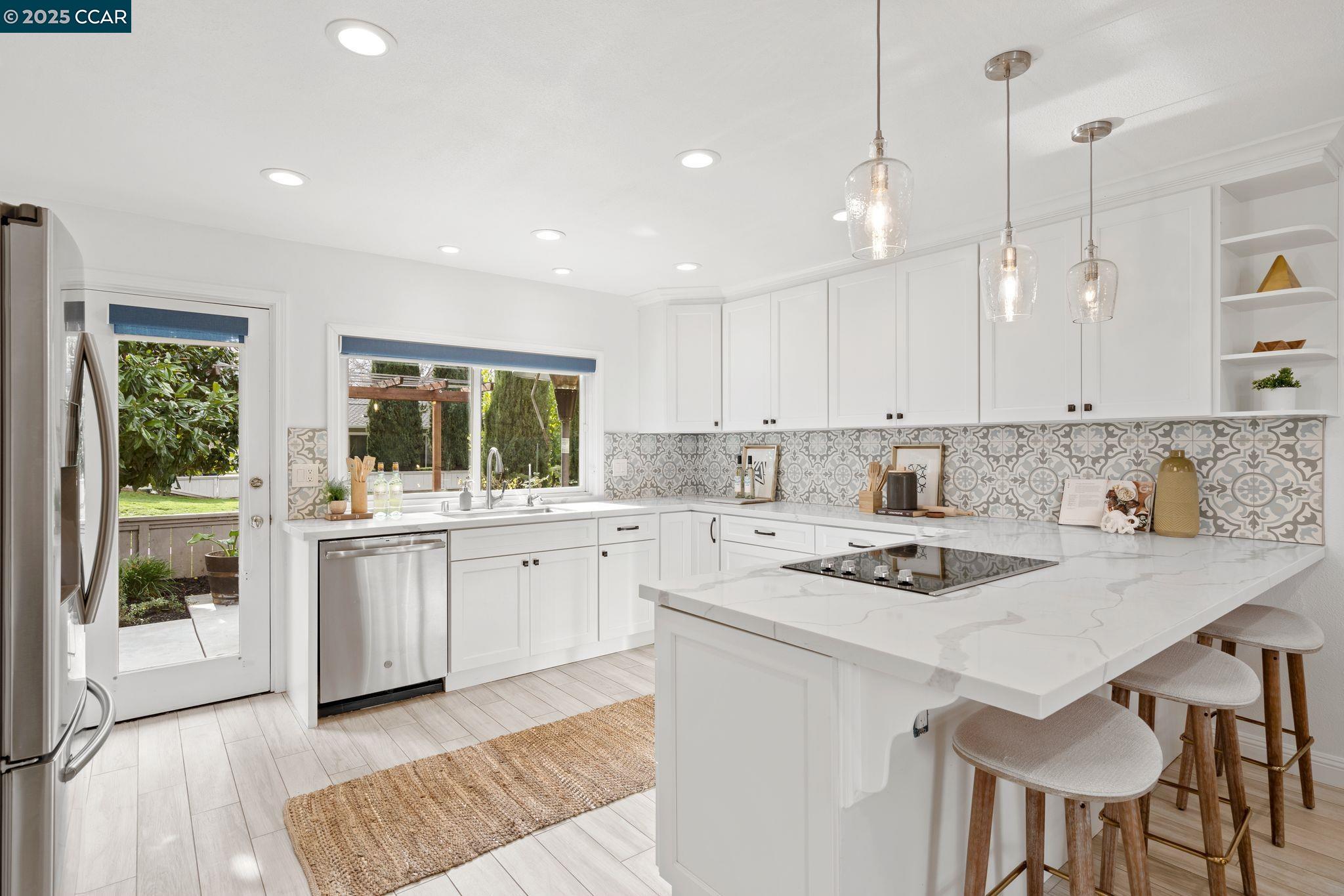 Located in the prestigious Crow Canyon Country Club, this stunning single-story, 4-bedroom, 3-bathroom home offers 2,137 sq. ft. of luxurious living space, with over $250,000 in exquisite upgrades.  Natural light fills the home, including a sunlit atrium that enhances the living areas. A redesigned layout connects the spacious kitchen to the family room, perfect for daily living and entertaining. The elegant living room features high ceilings and flows into the dining area for sophisticated gatherings. The updated kitchen boasts stainless steel appliances, quartz countertops, and custom cabinetry. Beautiful tile work enhances the remodeled bathrooms. Custom lighting, brand-new flooring, and fresh paint elevate the home's refined style.  The primary suite includes a large tile shower, sitting area, and customized closet. Additional remodeled bathrooms offer luxurious finishes, while custom hallway cabinetry provides extra storage. Outside, a beautifully designed patio and lush flowers create a serene retreat, while raised garden beds add charm. Owned solar panels and an EV charger ensure efficiency.  This gated community offers golf, tennis, pools, and a clubhouse. Minutes from City Center, top-rated schools, and 680, this home blends elegance, luxury, and convenience—a must-see!