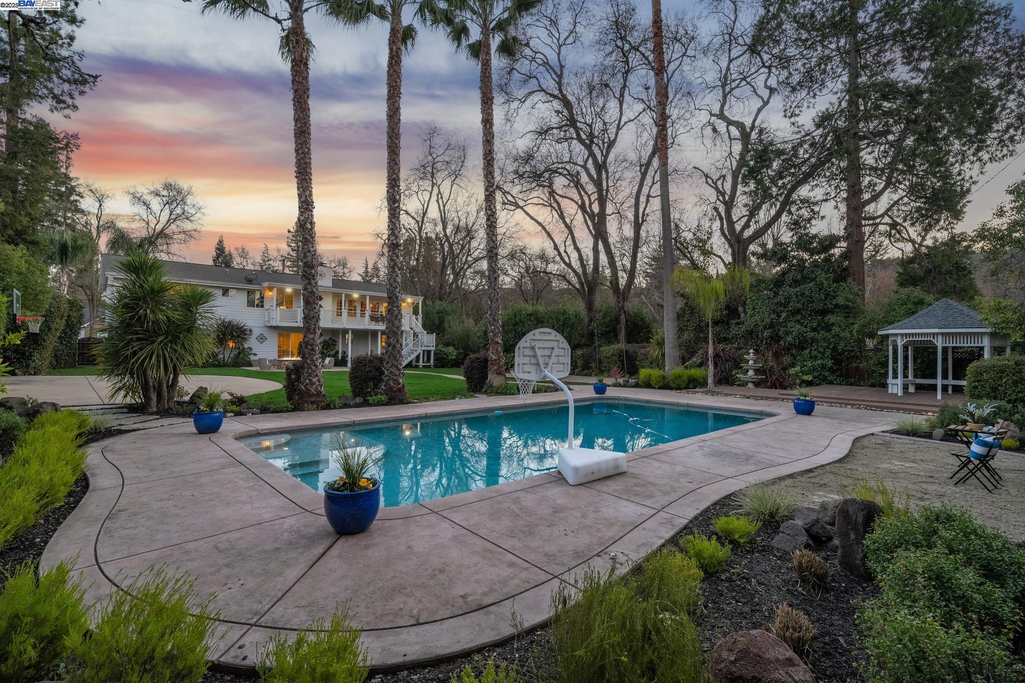 Welcome to your dream home situated in highly sought-after West Side Alamo, boasting a sprawling 1/2 acre flat lot perfect for active living. Featuring a pool, built-in fire pit, sport court, a covered gazebo, along with expansive patio & lawn areas. Appreciate a unique sandy beach area adjacent to the pool, ideal for relaxation & enjoying vacation vibes. With a functional floor plan encompassing 5 bedrooms & 4 full baths across 3,610 square feet, this home offers ample space for family & guests. The upper-level showcases inviting entertaining areas, including the primary suite and an additional bedroom with a full bath. The chef's kitchen seamlessly connects to a large deck, providing a picturesque view of the private backyard and an ideal setting for alfresco dining. The lower-level features three additional bedrooms, two bathrooms, & a cozy second living room with sliders opening to the backyard oasis. This could be a wonderful setup for an au-pair or extended house guests. The expansive backyard oasis, perfect for gatherings, is complemented by proximity to the Iron Horse Trail, hiking, biking, & top-rated schools, all nestled on a charming, quaint street. Room for RV parking and several cars in the driveway. Don't miss this opportunity to begin your westside lifestyle.