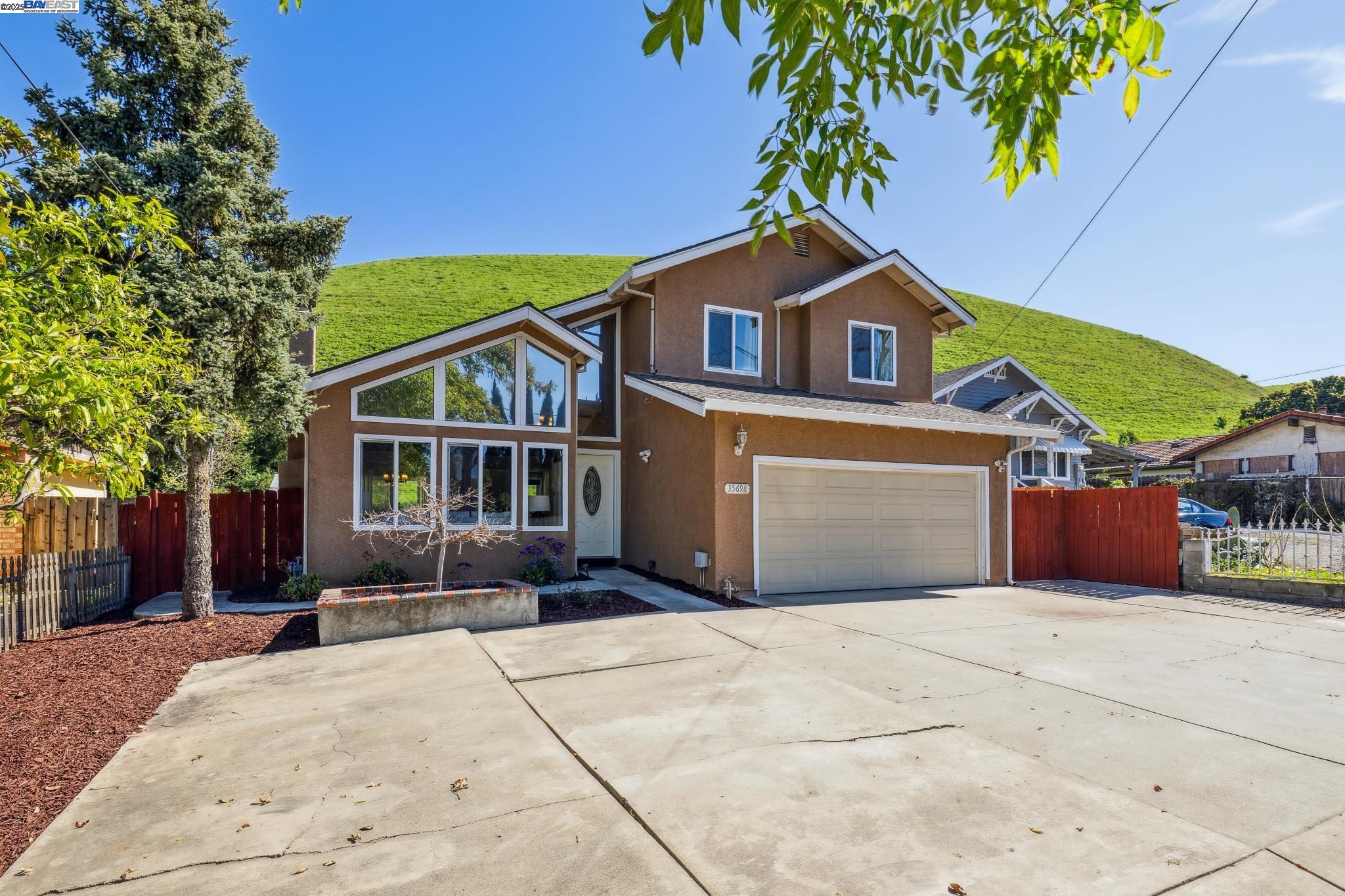 This beautifully updated 3-bedroom, 2.5-bath, 1,741 SF cabin-style home in the highly sought-after Niles district sits on a 7,217 SF lot backing to rolling hills. Featuring vaulted ceilings, hardwood floors, a modern kitchen with peninsula seating and new appliances, and a cozy living room with a fireplace, this home offers both comfort and style. The spacious family room provides potential for a 4th bedroom and full bath, while the primary suite boasts a walk-in closet, hill views, and an en-suite bath. The private backyard is a serene retreat with fruit trees, rolling hill views, and no rear neighbors. Located in a top-rated school district, this home is minutes from BART, I-880, I-680, CA-84, and historic Niles downtown with shops, farmers' markets, and parks. The gated driveway accommodates up to six cars, and smart home features include Ring security, Ecobee thermostat, and MyQ garage opener. Renovated in 2012 and updated in 2018, this peaceful home with no HOA is a rare find in a growing real estate market. Don’t miss out this amazing opportunity to own this great home!