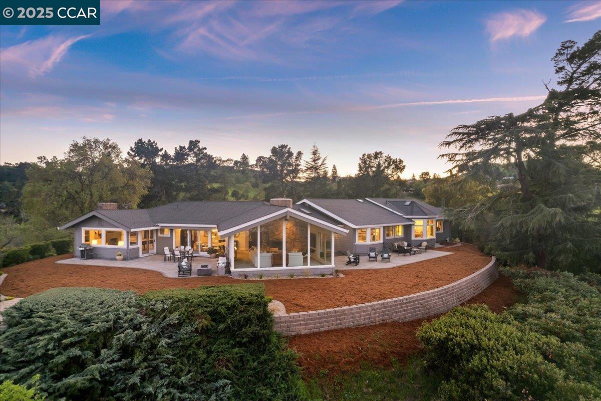 Live above the clouds on Acalanes Ridge. This 1.12-acre hilltop estate offers unmatched tranquility, sweeping views, and timeless mid-century modern design. A private 300-ft driveway leads to a 3,572 sq. ft. retreat featuring an all-glass living area, 3-car garage, workshop, car lift, and parking for 10+. Enjoy breathtaking vistas of Mt. Diablo, the Carquinez Straits, and city lights. The chef’s kitchen impresses with double islands, ovens, sinks, a 6-burner gas stove, built-in fridge, Cherry cabinetry and Walnut floors add warmth and sophistication. Five minutes to downtown Walnut Creek, BART, hiking; under 40 minutes to SF and Napa. First time on market since 1965.  Options are endless—here are 5 ideas: A. Embrace as-is—an irreplaceable sanctuary of calm and beauty. B. Add 2 stylish ADUs for guests, family, private retreats or income rentals. C. Install a private electric gate for the ultimate in privacy and access D. Build your dream multi-story mansion with panoramic views, pool, and resort-style amenities. E. Host unforgettable gatherings in one of the East Bay’s most exclusive hilltop settings.