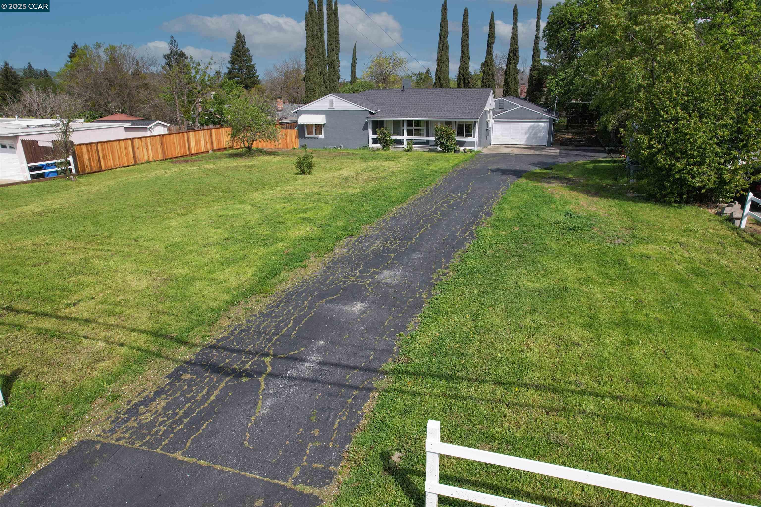 Nearly half an acre of flat property with a single story home tucked far off the road. The ranch style house offers 3 bedrooms with new carpet, and 2 full bathrooms in the main home. Enter to a great room area with laminate flooring, formal dining space, brick fireplace and abundant windows. The spacious kitchen features freshly painted cabinetry, dramatic granite counters, tile flooring, walk-in pantry/laundry room, and a large island. A freshly updated hall bathroom boasts tile flooring, new vanity, and tile shower over tub. Included in the square footage is a recently renovated, attached one bedroom, one bathroom "accessible unit" that offers laminate flooring, full kitchen and bathroom, living area, and a large bedroom. Highlights include: Replaced sewer line in 2025, new roof and electrical panel in 2023, fresh exterior and interior paint, fresh carpet in bedrooms, large side yard access on both sides, and dual pane windows. Conveniently located to restaurants, shopping, highway access and Larkey Park.