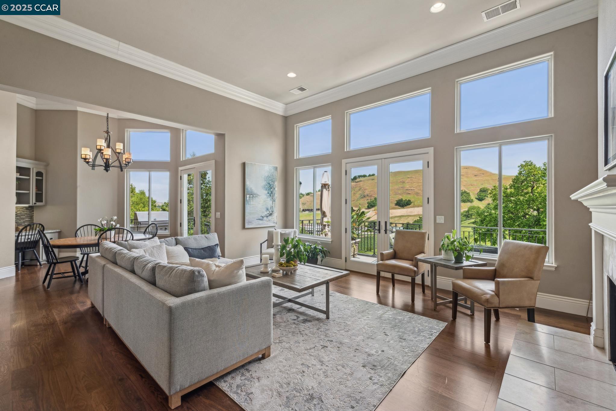 This light-filled, spacious and peaceful view property has the distinction of  significant flat yard in prestigious Roundhill North. Walls of newer double-pane windows and soaring ceilings bring the outside in. The updated kitchen with honed leather granite includes stainless appliances and butler’s pantry with amazing storage. The kitchen opens to family room and large balcony with views. Guest ensuite on main level. Gorgeous staircase with soaring windows leads to an impressive second foyer. On this level you find a game/theater room, gorgeous primary suite, another massive en-suite, two bedrooms and wine/storage panic room. 4 car garage. 1.7 miles to Roundhill CC with swimming, bocce, tennis and golf. Open Mother's Day Sunday 1-4pm come have a Mom-osa!