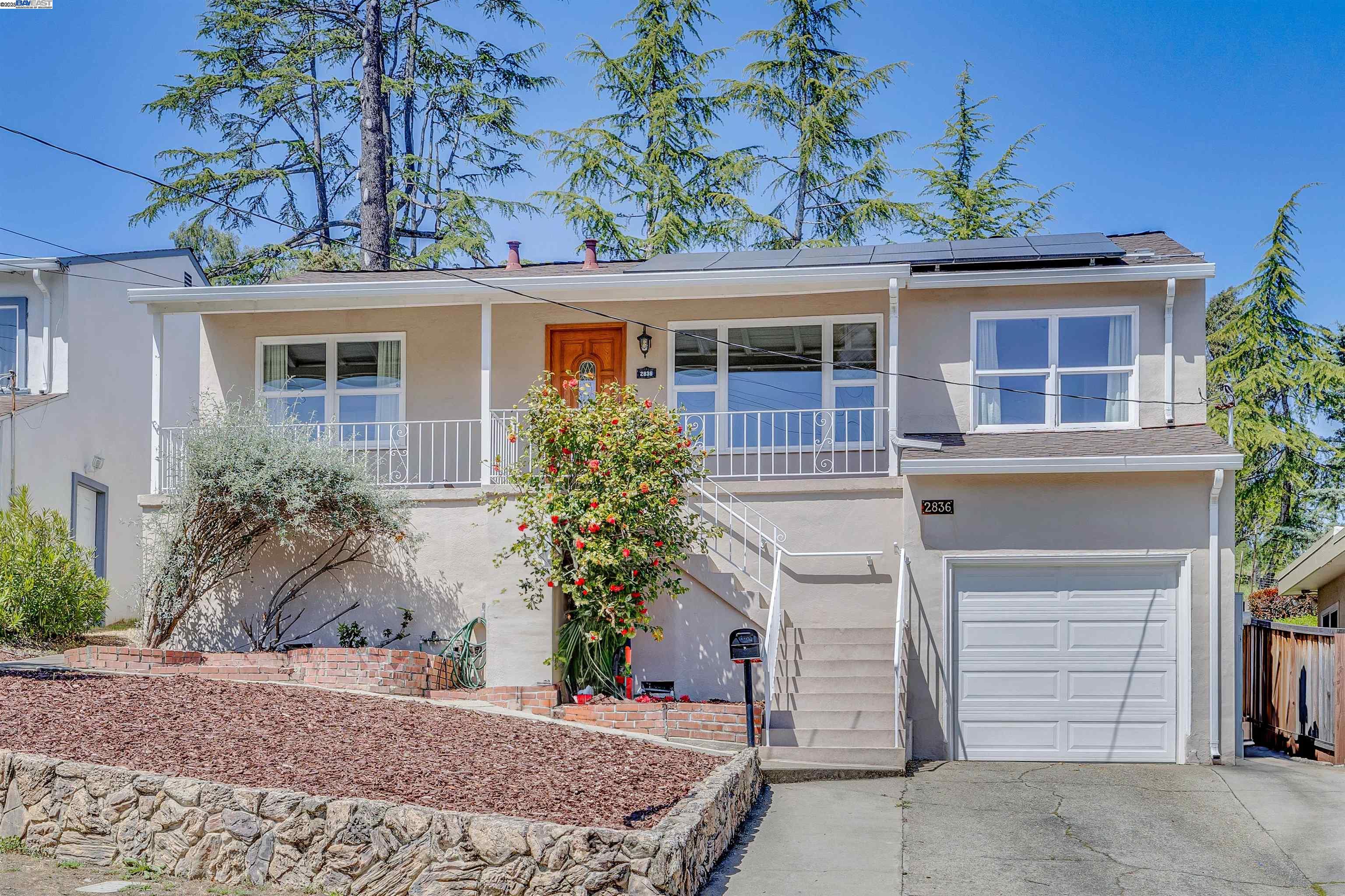 Price Improvement! This light-filled and cheerful home offers three spacious bedrooms and two full bathrooms, encompassing approximately 1,852 square feet of living space. The open-concept layout boasts hardwood flooring, an updated kitchen with granite countertops, a gas range, modern cabinetry, dual-pane windows, and a permitted sunroom. Stay comfortable year-round with central air conditioning plus a whole house fan and cost-saving solar panels. Additional upgrades include a French drain system, earthquake bolting for added security, a hybrid dual-pump water heater, an electric charger in the garage, and an automatic irrigation system in the backyard. Step outside to a peaceful backyard retreat designed as a bird and butterfly garden with native plants. Ideally situated near BART, major freeways, parks, dining, shopping, and top-rated Castro Valley schools.