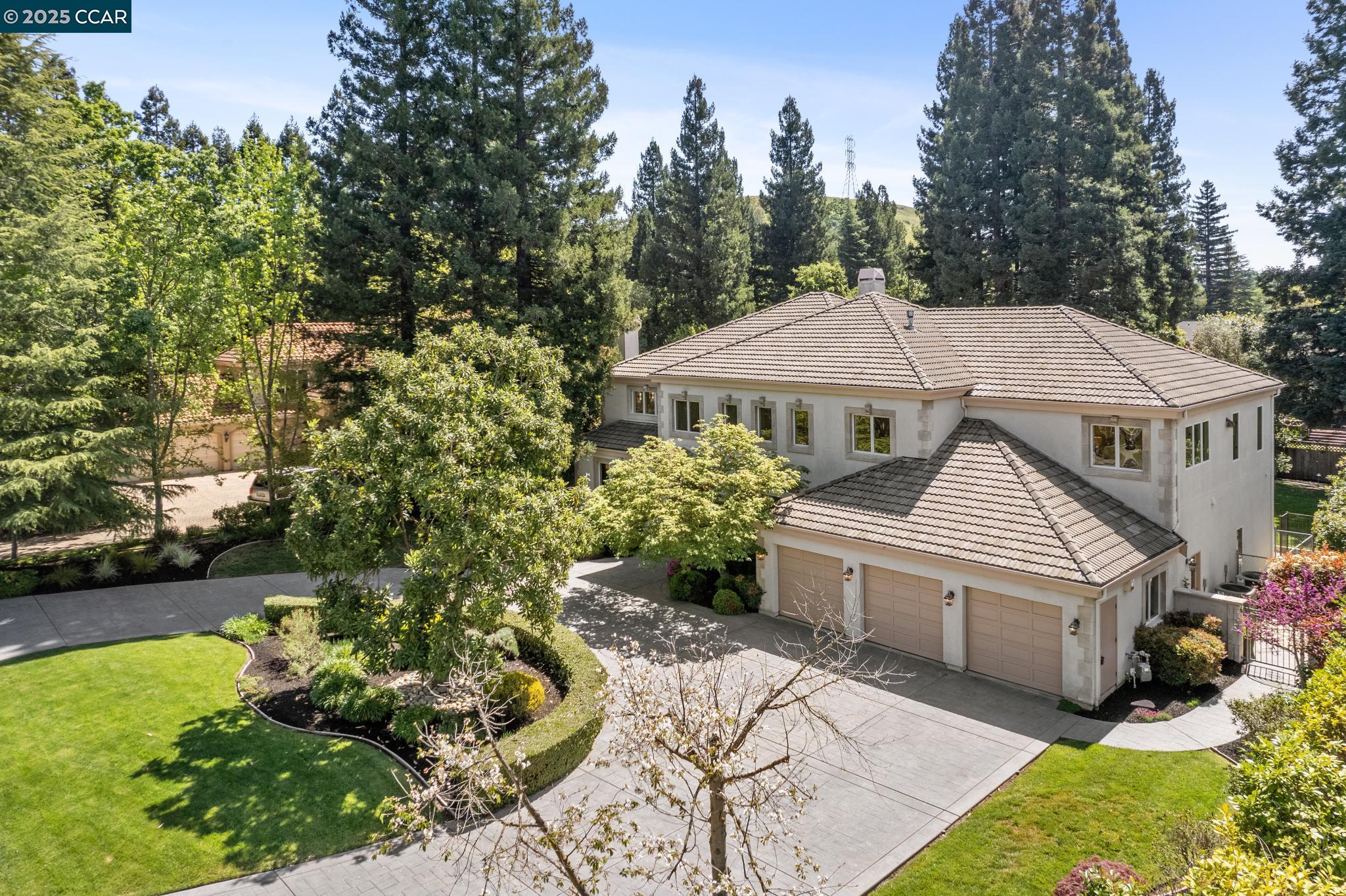 Located in a highly sought after gated community, a stunning estate greets you with an oversized half-circle driveway setting the tone for an impressive 5,300+ square foot residence. Formal entry boasts 18 ft soaring ceilings and marble flooring. Formal living room features wood floors and ornate hearth. An oversized dining room ideal for hosting is highlighted by large windows and coffered ceiling. Gourmet kitchen offers a large center island with bar seating, double ovens, walk-in pantry, and butler’s prep area. Open kitchen gives way to family room including a stone fireplace & sliding glass doors creating awash of natural light. Main floor additionally includes home office with rich wood details and guest suite with a full bathroom. Sweeping staircase leads to a regal primary retreat, complete with a large sitting area with fireplace, two walk-in closets, a wet bar with sink and fridge, and a spa-inspired ensuite bathroom. Upstairs also features three generously sized guest bedrooms, including one en-suite, along with a spacious bonus room. Entertainers backyard with pool/spa, bocce court and multi seating areas. A 4+ car garage accommodates all of ones needs for storage or a home gym and more.