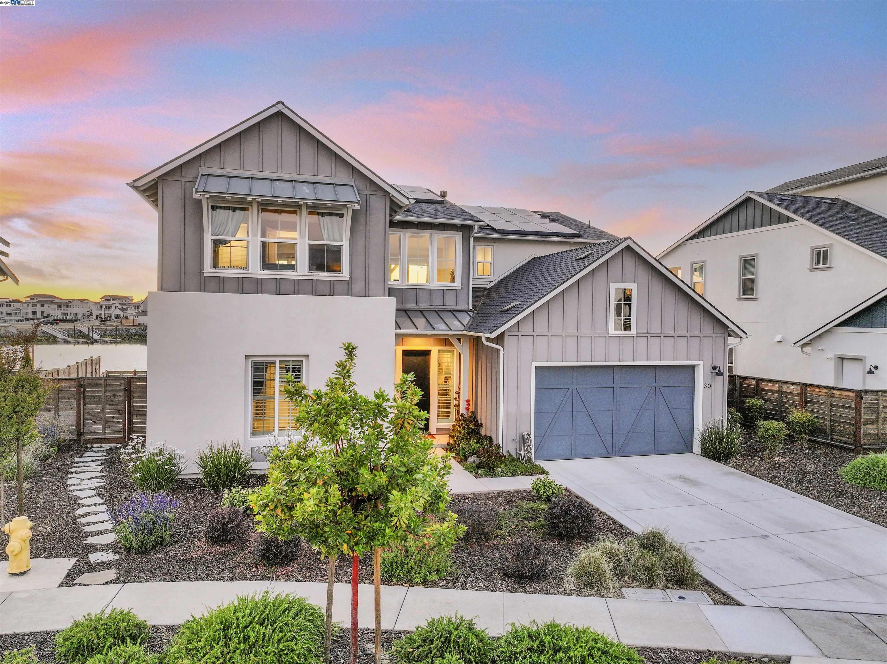 Welcome to 30 Grey Whale Place where luxury and serenity meet!  This open concept floorplan offers breathtaking views & natural light from the many windows & exceptional entertaining opportunities to enhance your indoor/outdoor living with the upgraded first floor sliding doors out to the backyard, where you can relax & unwind on your prewired finished delta patio. Downstairs offering a primary suite with a large bathroom, walk-in closet with private laundry, secondary guestroom with private bathroom, great room with fireplace, chef's delight kitchen with extended cabinets, dining room, & guest's half bath.  Upstairs is a large loft, work from home space, & 2 additional secondary bedrooms, each with private bathrooms, & a second-floor balcony space for sunsets, weekend unwinds with a good book, coffee, or wine on the patio!  Private dock, side yard space, low maintenance landscaping, dusk to dawn lighting, prewired for your EV, owned solar & enjoy the HOA amenities: Yoga Studio, Gym, Pool/Jacuzzi, Clubhouse, Firepits, Outdoor Kitchen, Playground, Greenbelt, Boat Slips, Dog Park, Walking Trail, Sand Volleyball, and Half Court.  This home boasts too many upgrades to list them all online; a tour of this luxurious property will showcase the many things there are to love.
