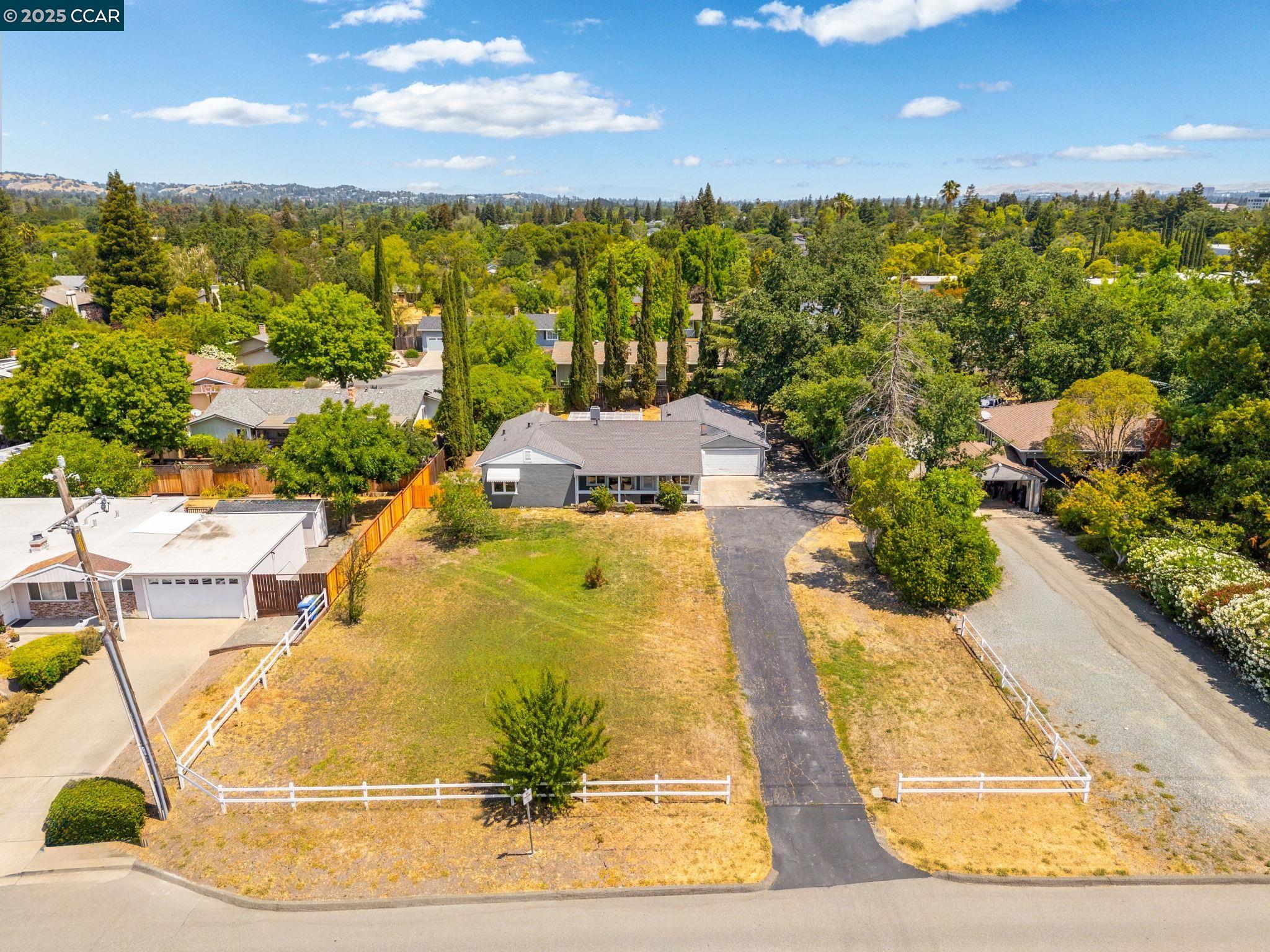 Exceptional opportunity in Walnut Creek: 3BD/2BA main home + 1BD/1BA attached ADU on a nearly half-acre flat lot (approx 20,909 sq ft). Whether you're looking for room to grow, multigenerational living, rental income, or simply extra space, this property delivers. The single-story main residence offers a traditional layout with a spacious living room featuring a fireplace & picture window & separate dining room just off the kitchen. The kitchen includes a center island with bar seating, generous counter space & ample cabinetry for storage. All 3 bedrooms are well-sized, including a rear bedroom with sliding door access to the deck & yard, 2 bathrooms & laundry room complete the main home. The ADU has its own entrance & is fully equipped with a kitchen, living & dining space, full bathroom, bedroom & in-unit laundry—an excellent setup for guests or rental income. Outside, the expansive flat lot offers endless possibilities. Enjoy the existing pergola-covered deck, patio seating area, mature shade trees & a variety of established fruit trees. Room to add a pool, garden beds & additional outdoor features. A long driveway provides parking for multiple vehicles. Located on a quiet residential street just minutes from downtown Walnut Creek, BART & top-rated schools.
