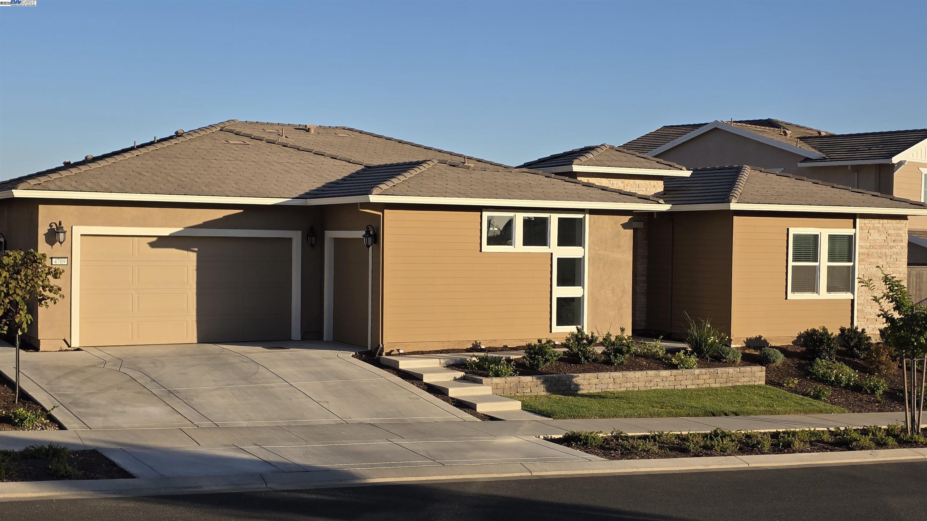 Welcome to the Platinum Peak Neighborhood of the Russell Ranch Community and explore this exceptionally designed very spacious single level 3554 sqft home on a large lot featuring five bedrooms five and half baths, a Next Gen Suite complete with kitchenette, laundry and its own private entrance all well suited for multigenerational households or a large family or even a home based business. Ideally located with access to premier shopping, restaurants, healthcare and schools, some of the key features of this property include: Owned solar, clubhouse recreation facilities within walking distance, no front or rear neighbors, expanded driveway with 3 bay garage, a welcoming courtyard with covered porch, office at the entry area, Chef's kitchen with extra large island, upgraded GE Cafe brand stainless steel appliances with built in refridgerator, 8 ft electric fireplace in family room, spa like master bath with dual shower heads in large walk in shower, multi-stacking sliding door off family/dining rooms that leads to the california room with fireplace and out into a well designed backyard with amazing views. This beautiful home is ready to welcome you  to this prestigious newer neigborhood for you and family to enjoy all that it has to offer!