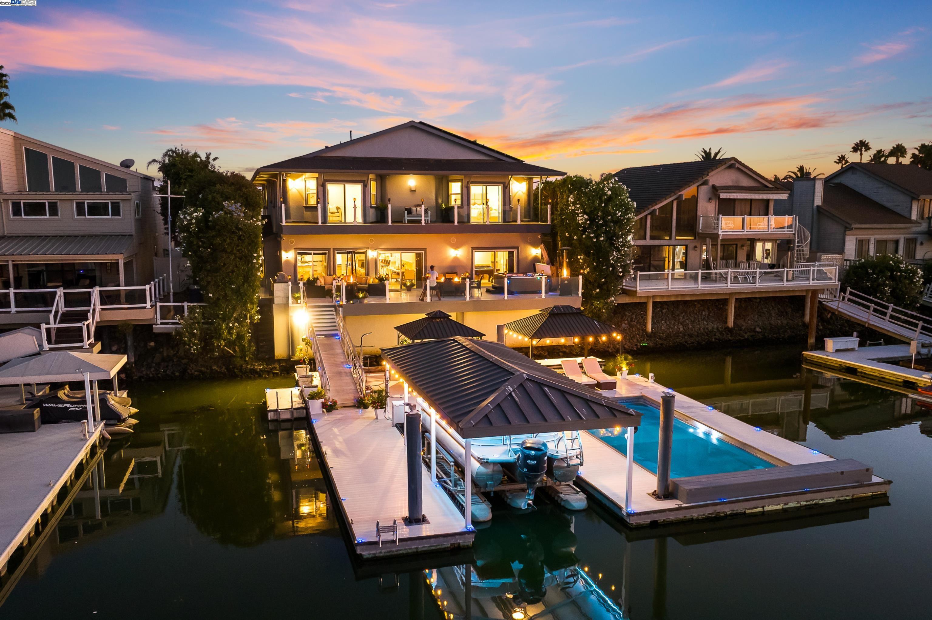 Once-in-a-lifetime opportunity! This spectacular waterfront estate is designed for the discriminating buyer with breathtaking views of the Delta waterfront and seconds from fast water! Enjoy plenty of space & luxury for all with this 5,348 sqft home offering everything one could ever want. The moment you step inside, the gorgeous foyer will impress! Exquisite and sensational planning, master craftsmanship and the highest quality materials are a consistent theme, delivering both comfort and style. The massive great room features a captivating bar with panoramic views of the water and deck. The spectacular chef’s kitchen features custom cabinets, oversized island, granite counters. Main floor has two bedrooms and two full bathrooms, perfect for multi-generational living or guests. The luxurious primary suite features stunning water views, walk out balcony with glass panels, huge walk-in closet, atrium, exquisite spa-like bath w/sauna. Upstairs there is also two bedrooms, media room/6th bedroom, hall bathroom, and a laundry room. Deck has BBQ, hot tub, floating pool, covered HydroHoist & see-doo slips, shower, speakers! COME HOME TO YOUR PRIVATE RESORT EVERY DAY! Open Sat/Sun 1-4
