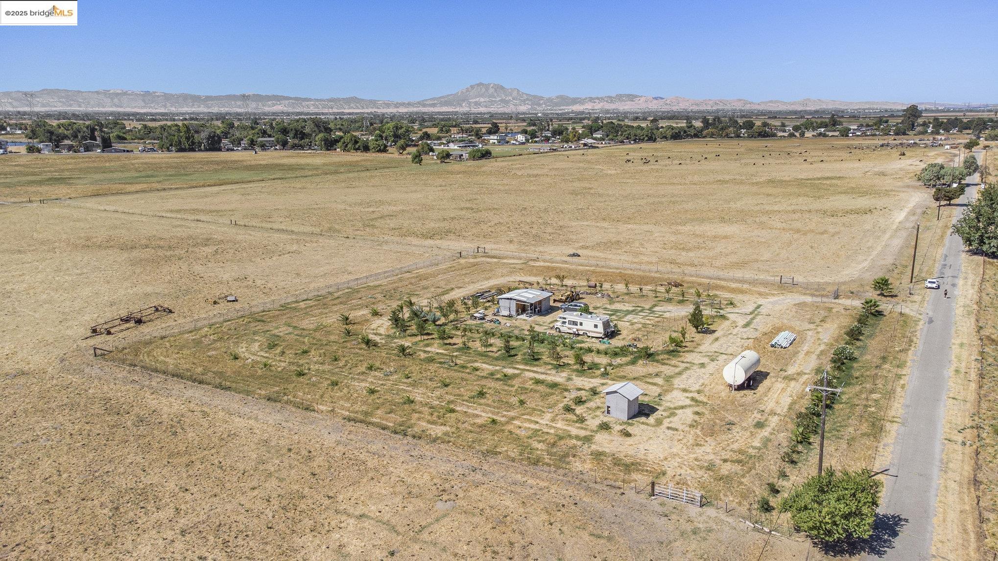This is an opportunity for a developer to entitle this property to utilize for its potential allowed by the General Plan. There is mixed zoning on this parcel. The frontage on bethel Island Rd is 500 ft. of Commercial. The Commercial portion is approximately 2.5 acres in total. The back section of the property is zoned agricultural. With all the development in the area, including 1000's of homes coming on Bethel Island and Cypress Rd., this will be a great piece to hold and or develop. Please Check with Contra Costa Planning for any of your development questions. Owner has planted overt 100 Trees in a fenced section at the back of the property. These include Plums, Dates, Persimmon, Almond, Pecan, Peach, Cherry, Fig, and Apricot. In this section there is a well 280 Ft deep and seller has set up irrigation for the trees feeding from a 7500 gal storage tank.  Information provided to be confirmed with County Planning