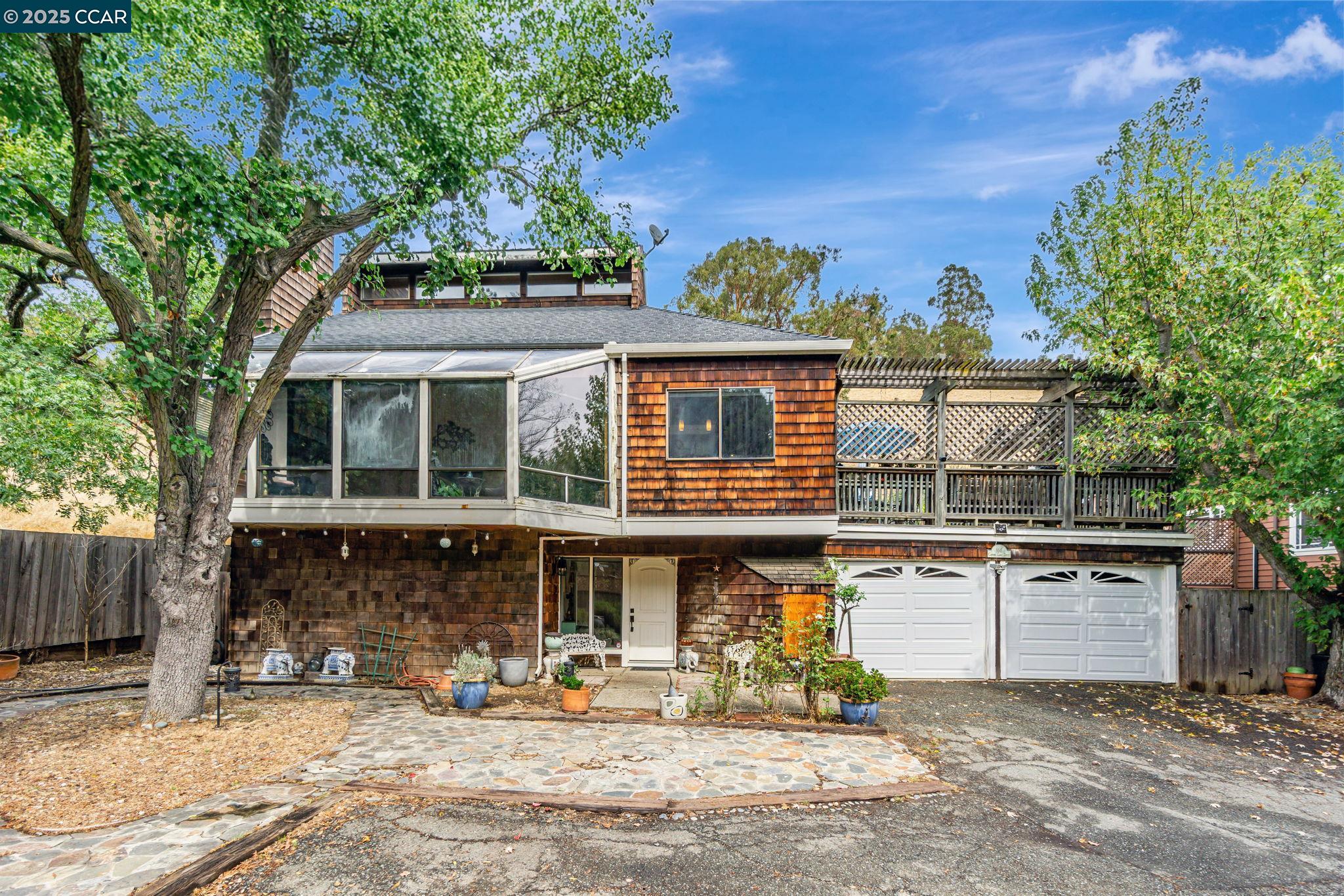 Located in the distinctive and artistic community of Port Costa, this beloved, three-bedroom, three-bath tri-level offers immense potential and is ready for its next owner. The home features a unique, contemporary design with high natural wood ceilings and expansive glass walls, creating an abundance of natural light throughout the main level and master bedroom loft. This open layout is ideal for entertaining or simply enjoying a serene living space. French doors from the kitchen and great room open onto a private deck, offering views of rolling hills—a perfect spot for quiet relaxation or gatherings with loved ones. With one bedroom and a full bath on each level, the home also provides an enhanced sense of privacy. The yards are spacious with plenty of room to garden, play and let your favorite furry friends roam happily. This property offers a rare opportunity to enjoy a vacation-like retreat while remaining just a few miles from urban amenities.