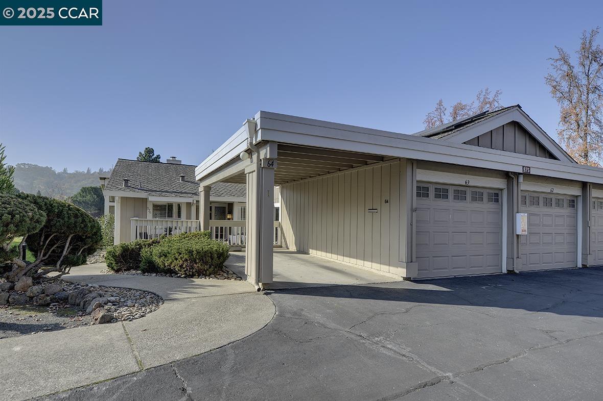 Tucked away in one of the most desirable spots on Terra California Drive, this wonderful single-level Tahoe–style condominium radiates warmth, comfort, and effortless elegance. With over 1,700 sq. ft. of beautifully lit living space, this rare gem offers two bedrooms, two bathrooms, a versatile den, and a sunny finished sunroom that feels like a peaceful retreat. Enter through the charming gated front patio and step into an inviting foyer that flows into a grand living and dining room with soaring ceilings, walls of windows, and a cozy fireplace—perfect for relaxing or entertaining. The updated kitchen is bright and cheerful, ideal for morning coffee or evening meals. Just off the living room, a generous den provides the perfect nook for a home office or media room. The private primary suite is thoughtfully designed with custom built-ins and an updated bath, while the guest bedroom enjoys its own access to the front patio, creating a welcoming haven for visitors. A full guest bath and separate laundry room add convenience to everyday living. With new LVP flooring, true level-in access, a garage plus carport, newer HVAC, and an exceptional location steps from clubhouses and ample guest parking, this home offers a rare blend of style, comfort, and ease—simply a delightful place to